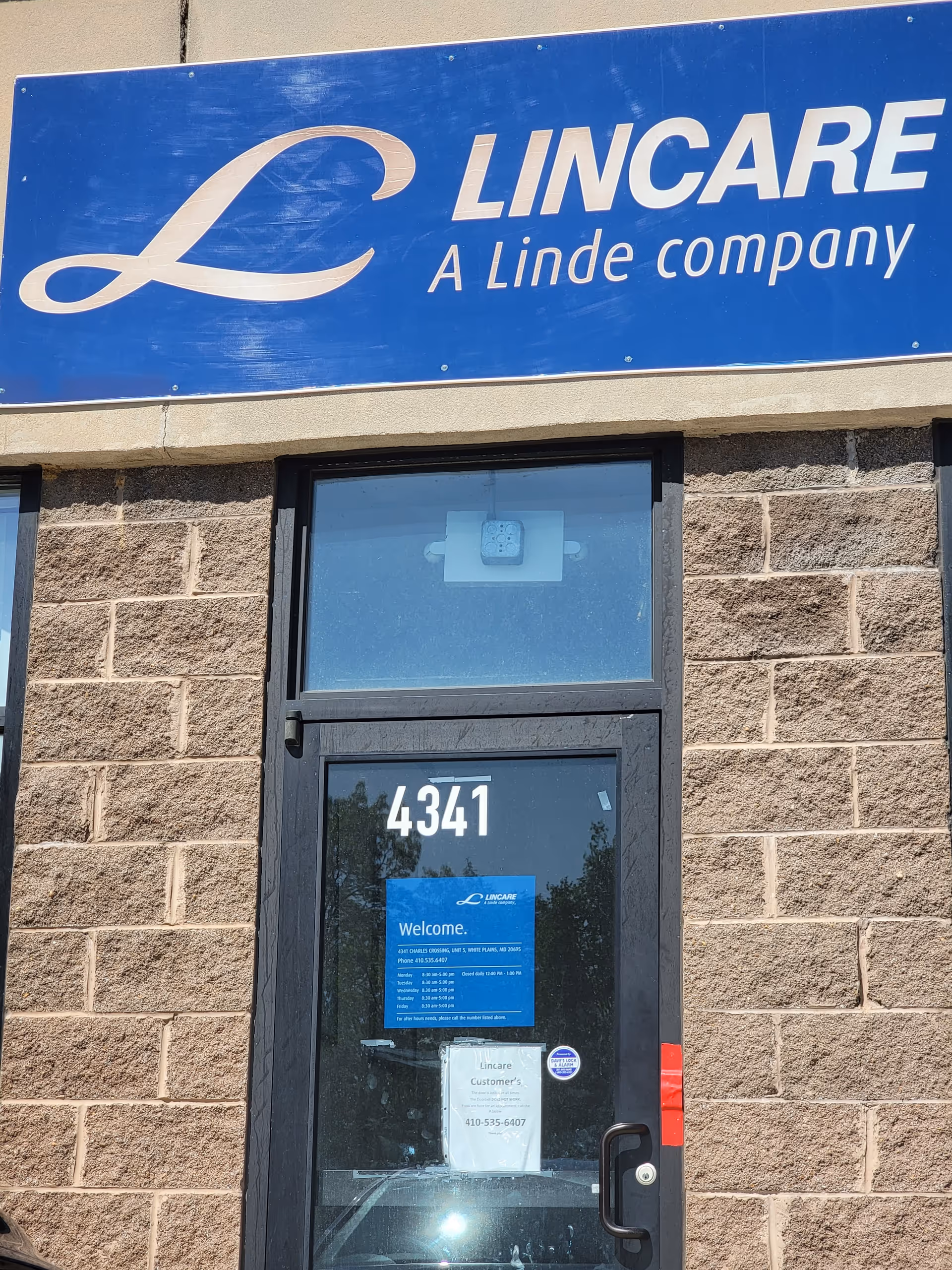 Blue LINCARE sign above brick building entrance with a glass door and 4341.