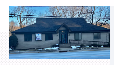 Front view of a Senior Helpers facility building with a sign near the entrance.