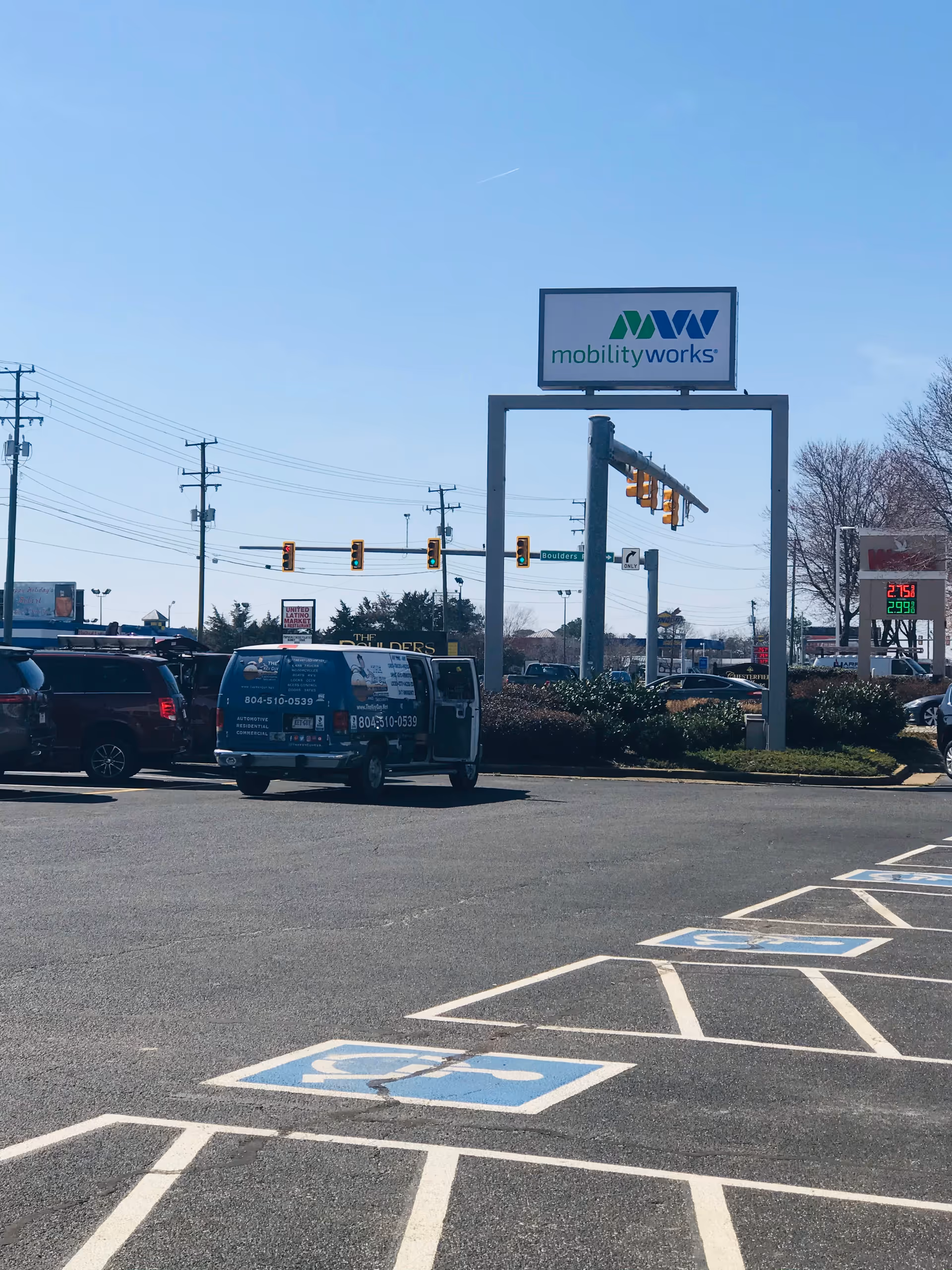 Exterior view of MobilityWorks sign above a parking lot.