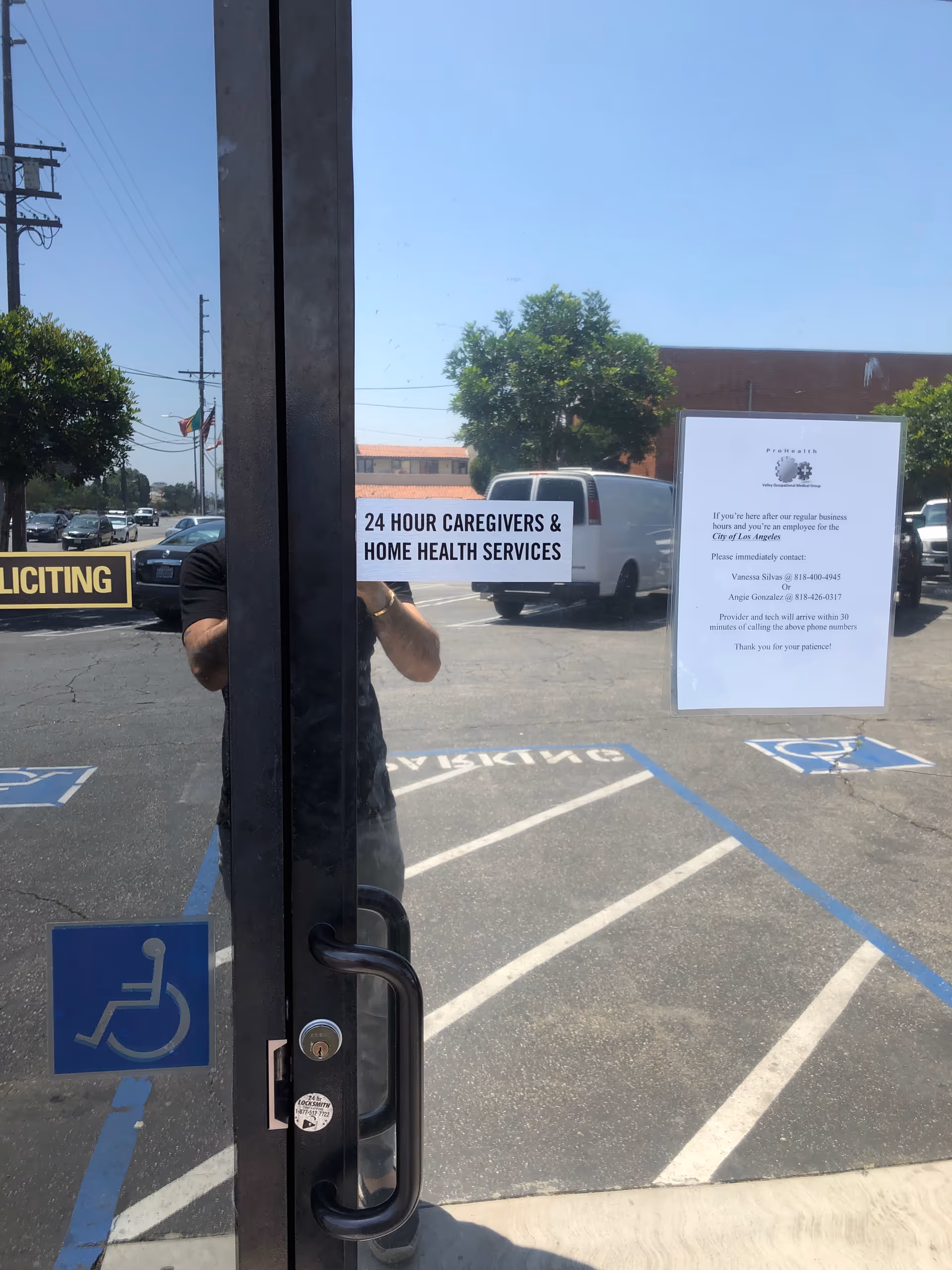 Glass storefront door with signs for 24 Hour Caregivers and home health services.