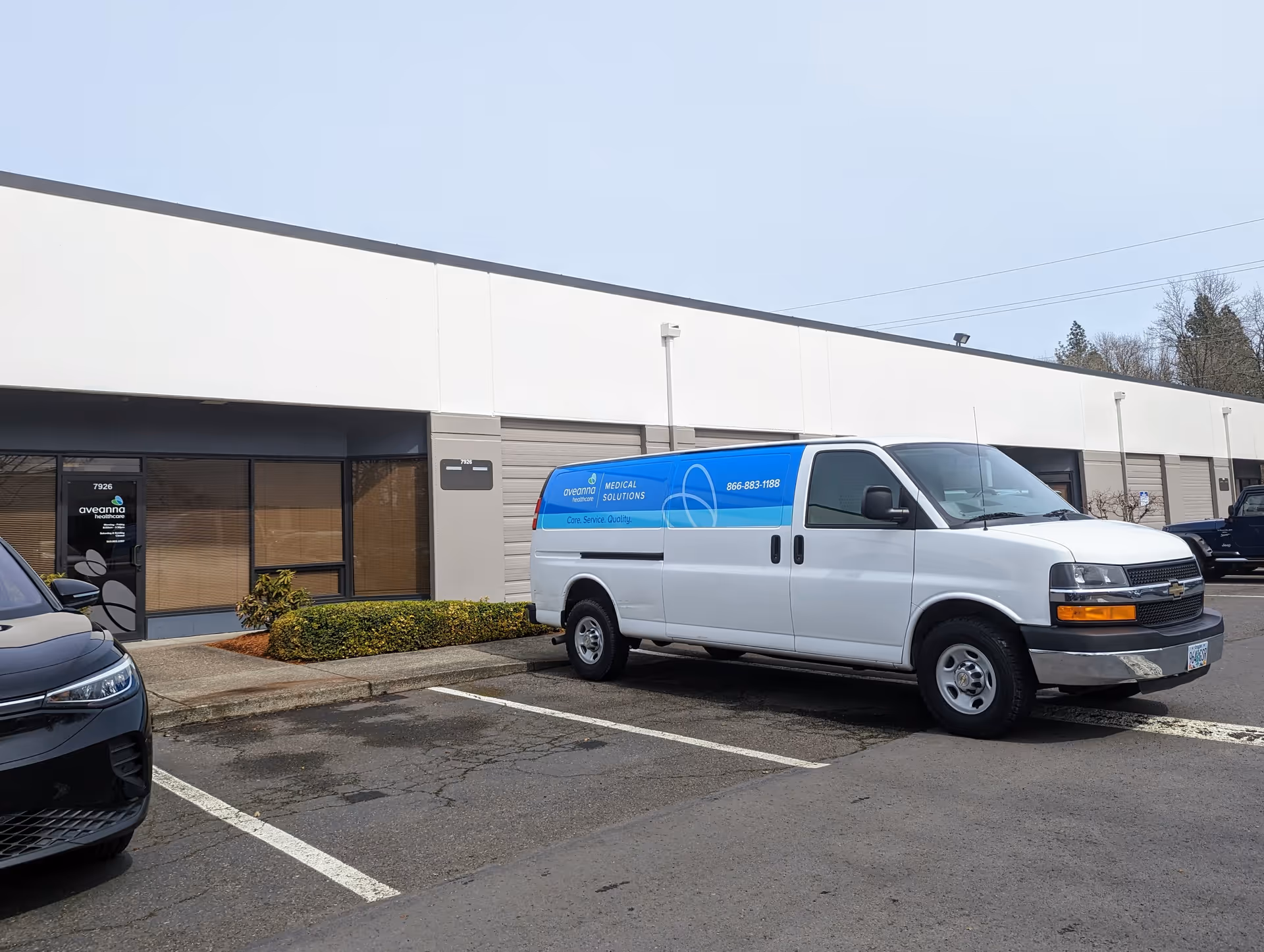 Exterior view of Aveanna Healthcare building with a white and blue service van parked in front