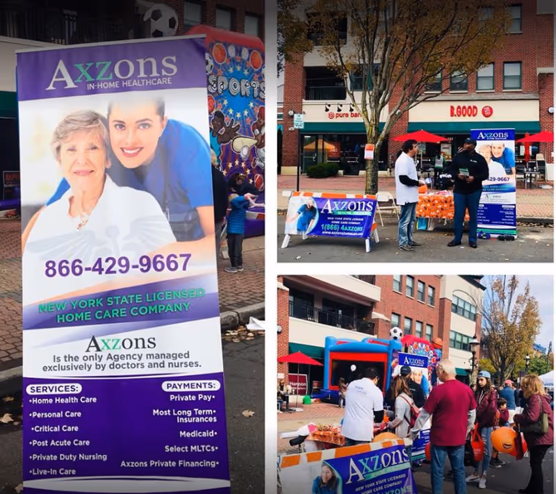 Outdoor Axzons Homecare promotional event with large banner, tables, and attendees.