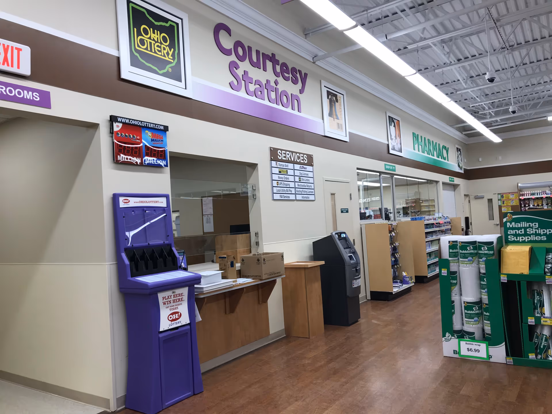 Interior of Discount Drug Mart with courtesy station and pharmacy signage visible.