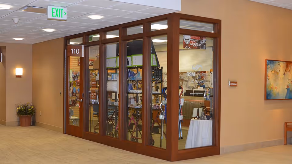 Interior hallway with glass-front storefront and signage for SSM Health at Home.