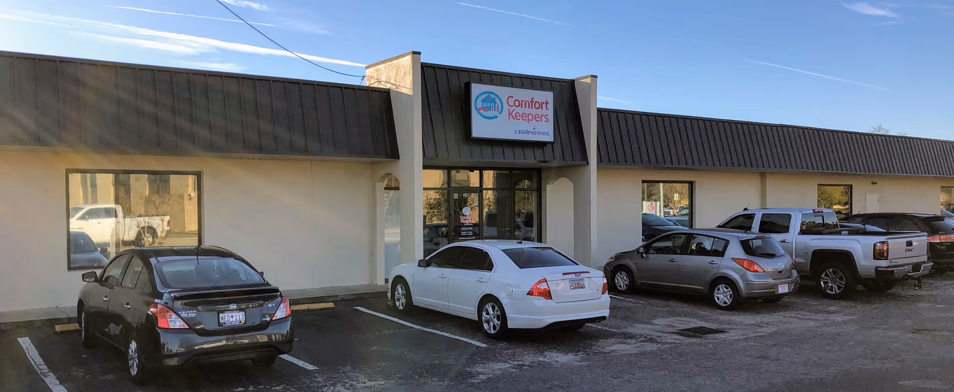 Front view of Comfort Keepers Home Care with cars parked outside.