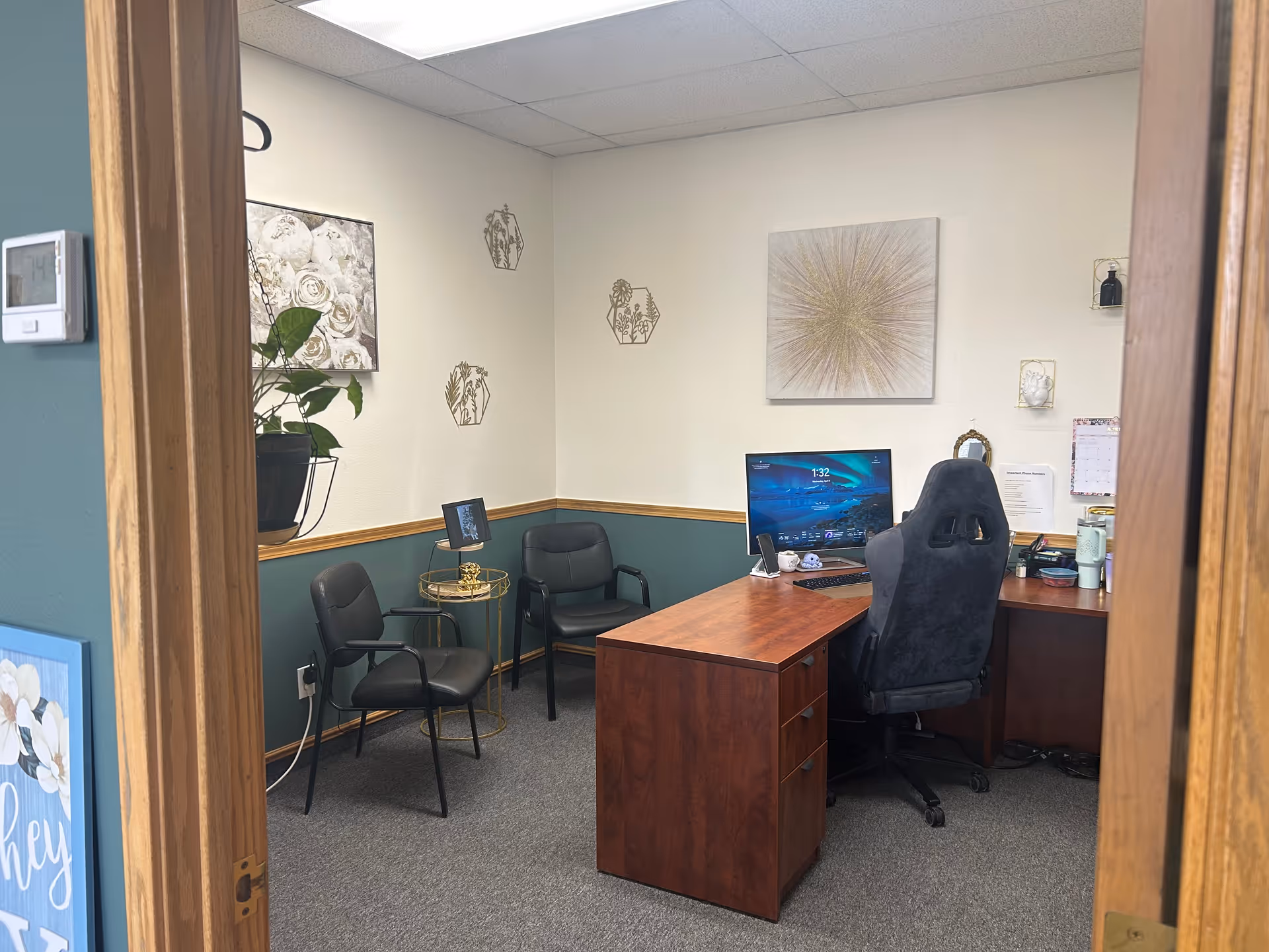 Office-style consultation room with desk, computer, and several chairs in a senior care facility.