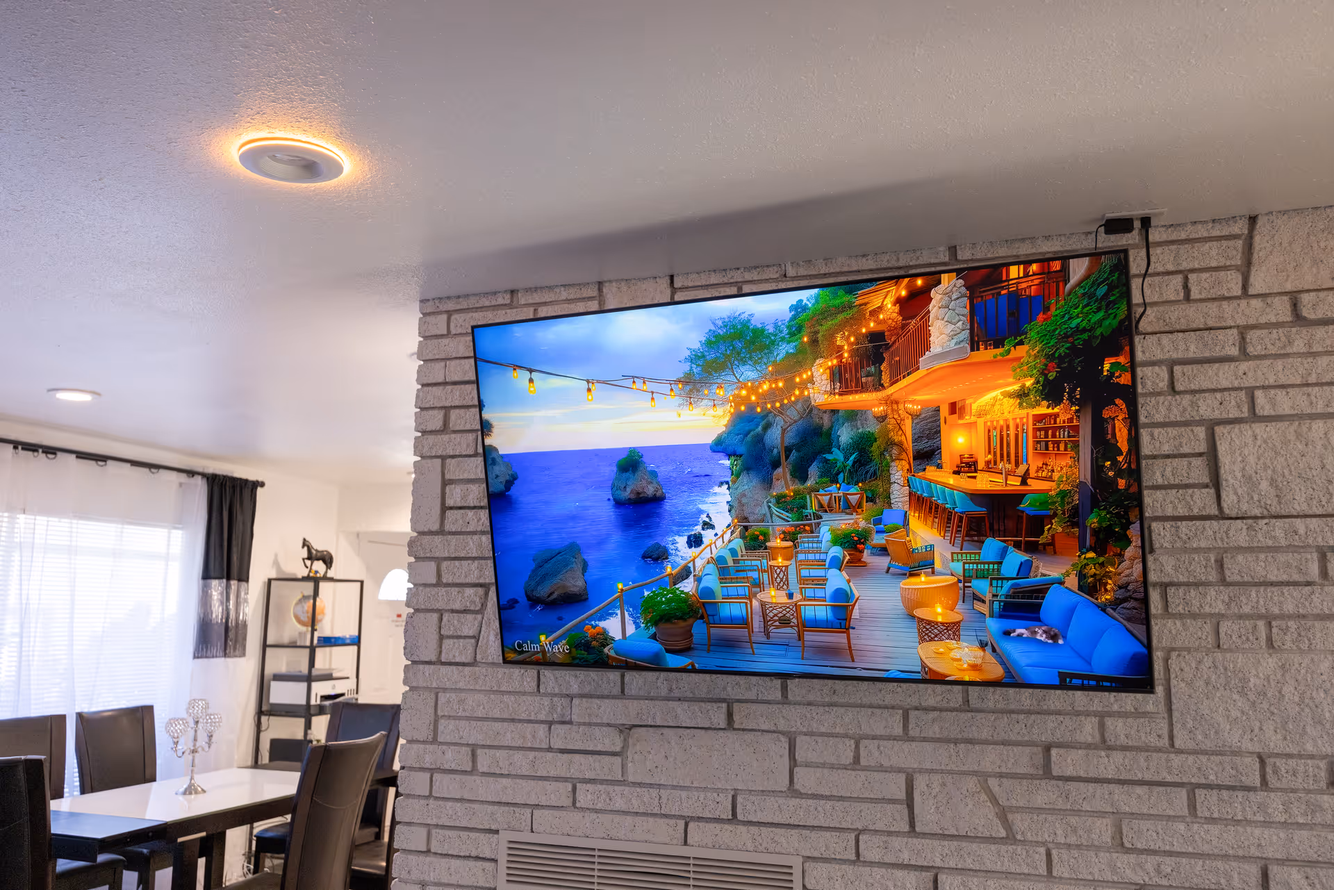 Interior living area with a wall-mounted TV and dining table.