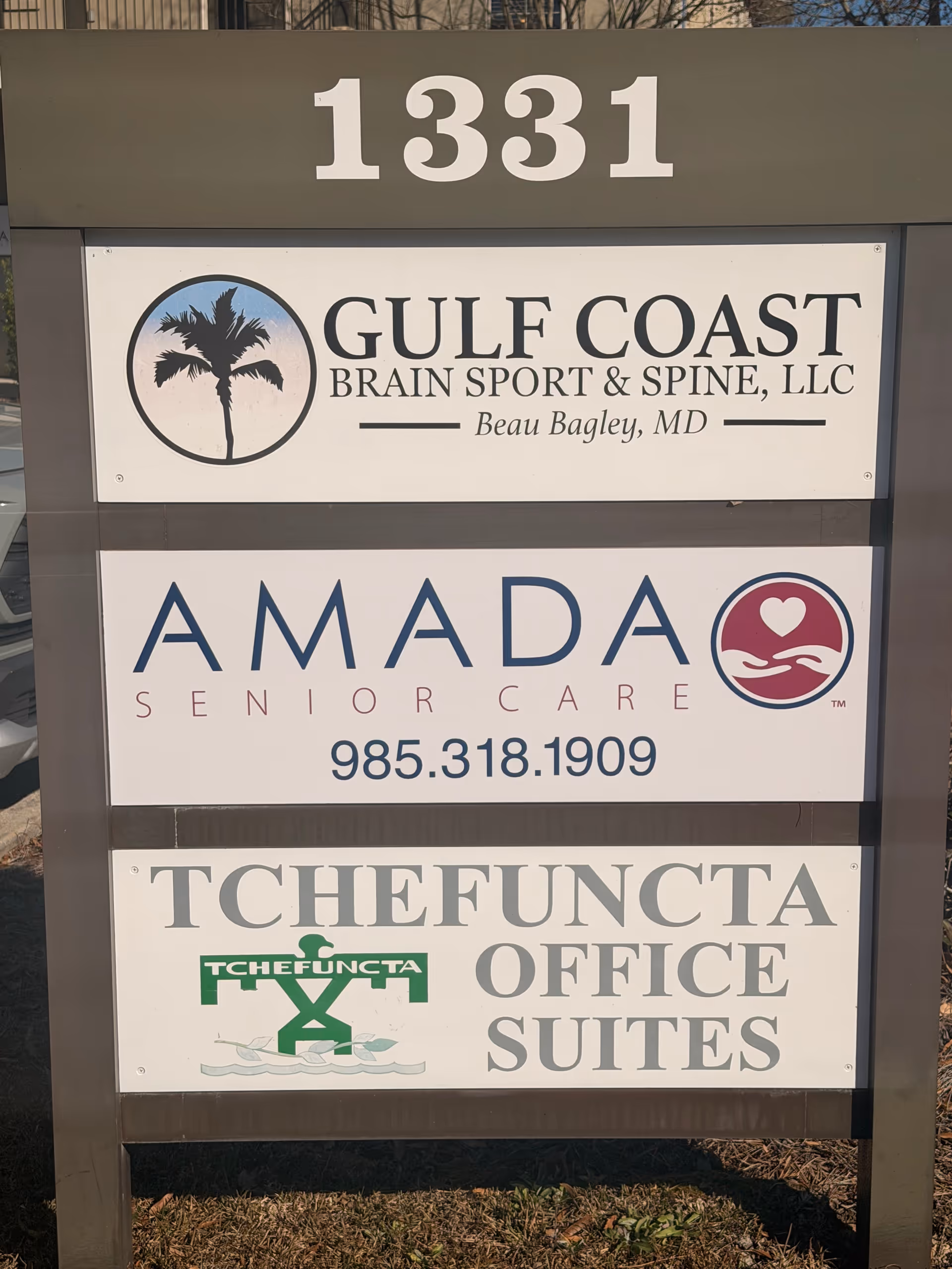 Outdoor building signboard displays Amada Senior Care and other businesses, 1331
