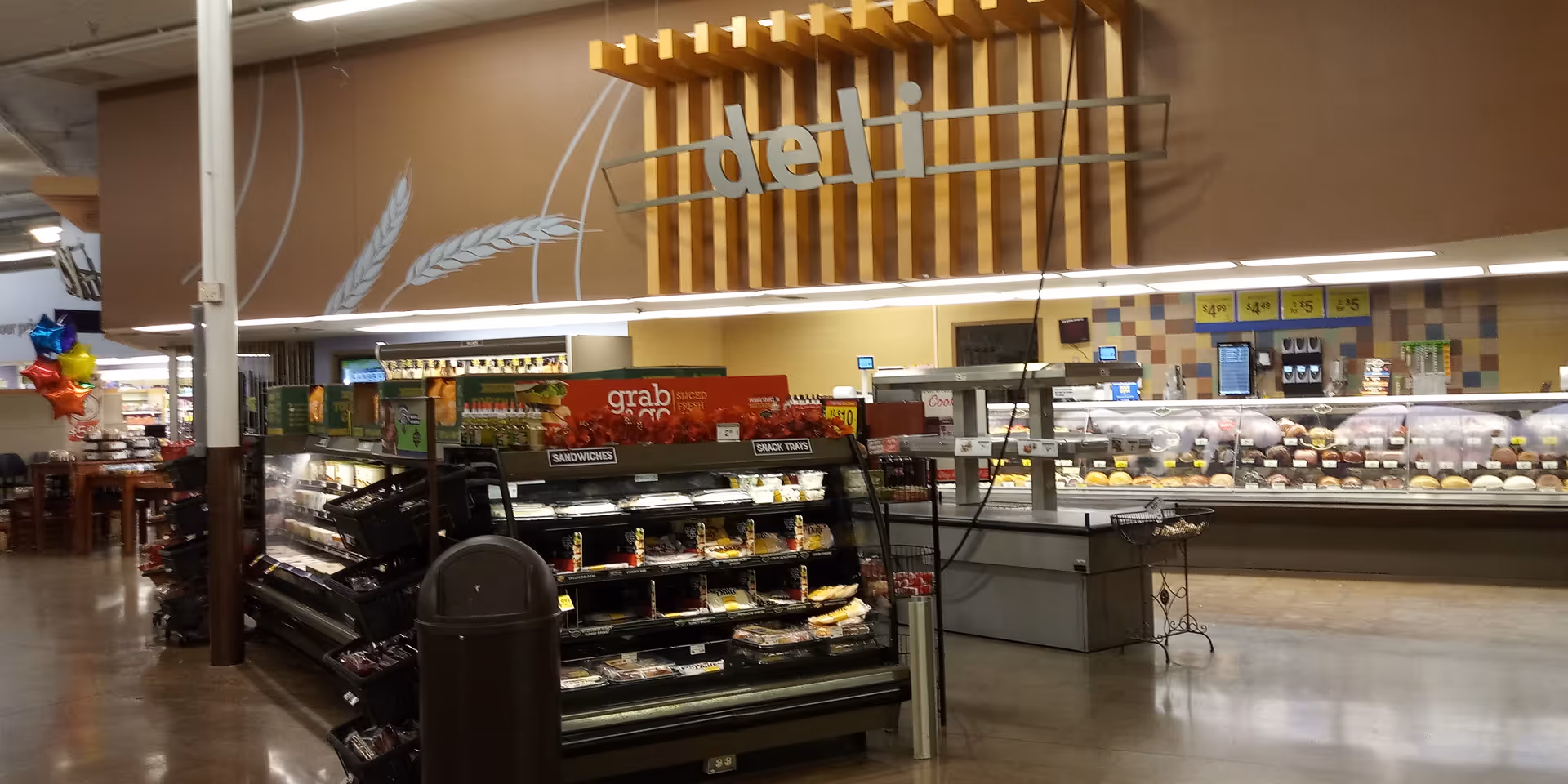 Inside a Kroger store deli area with display cases and deli sign overhead