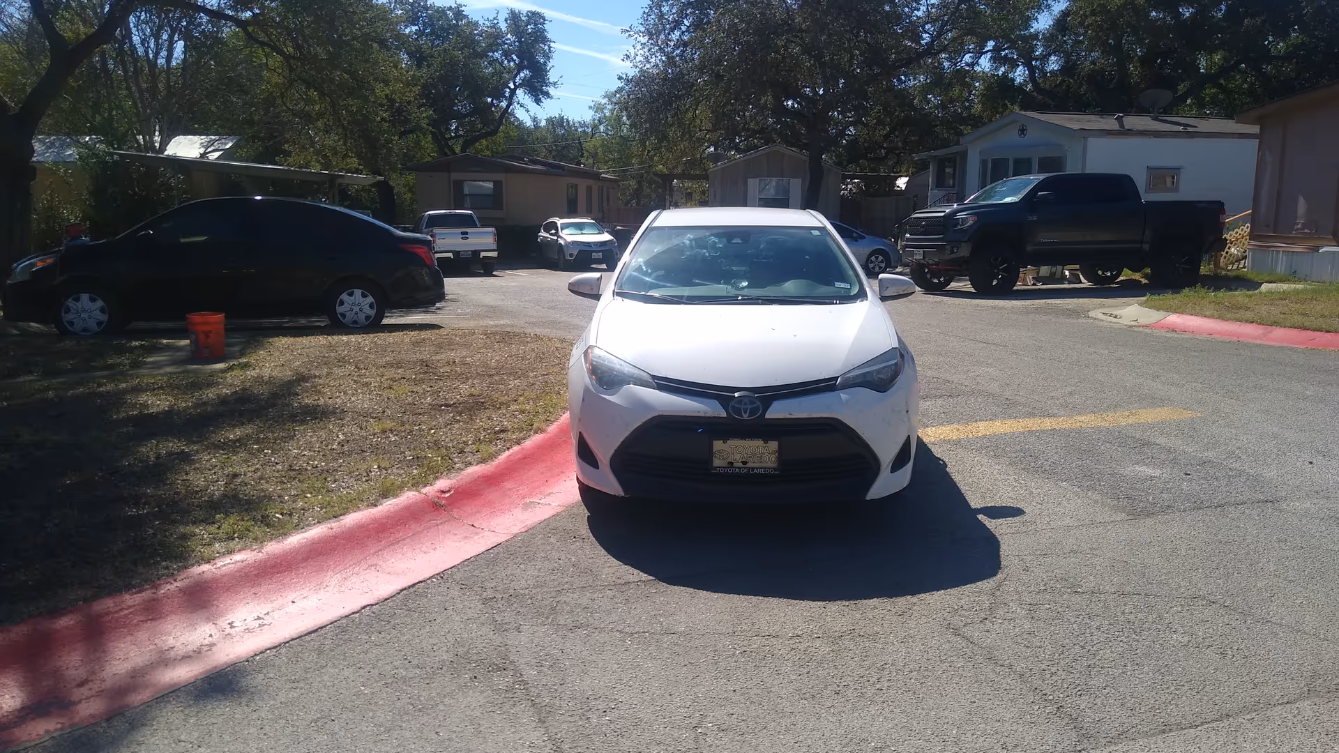 White sedan centered in a parking lot beside the BrightStar Care facility exterior.