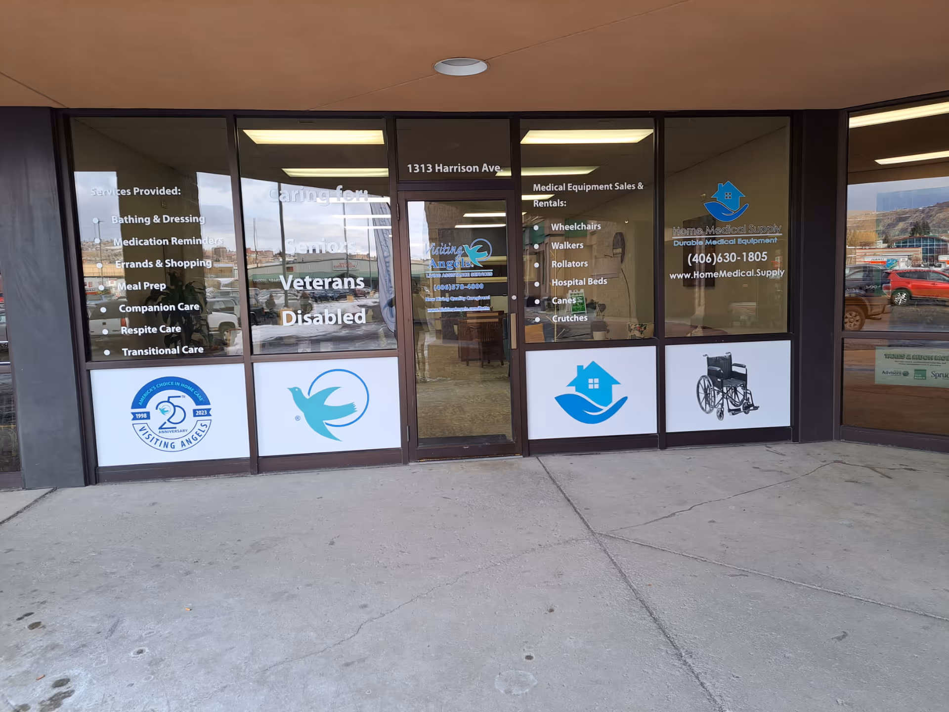 Front of a Visiting Angels Senior Home Care storefront with glass doors and signage.