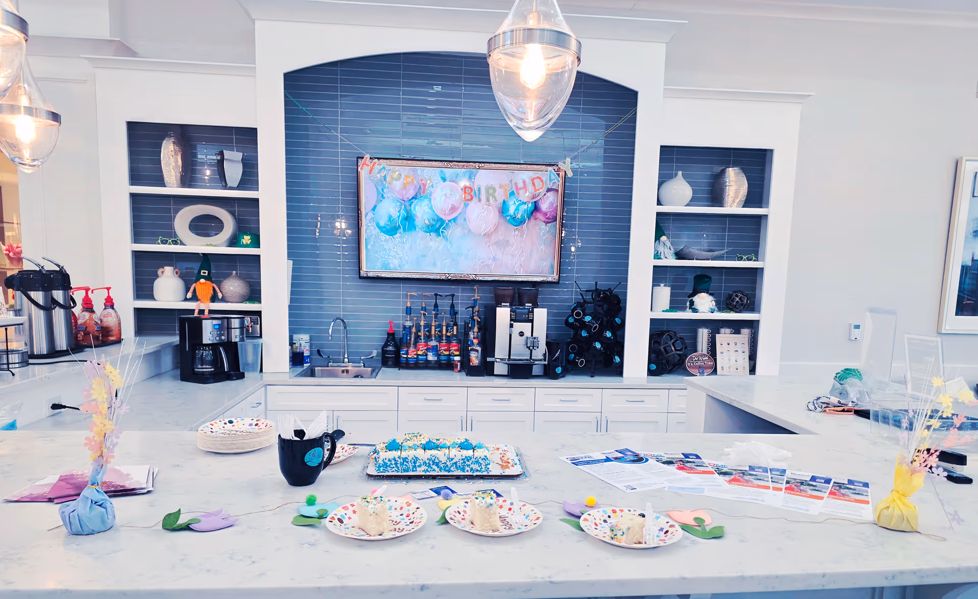Bright dining area with a party table, birthday cake, plates, and beverage station.