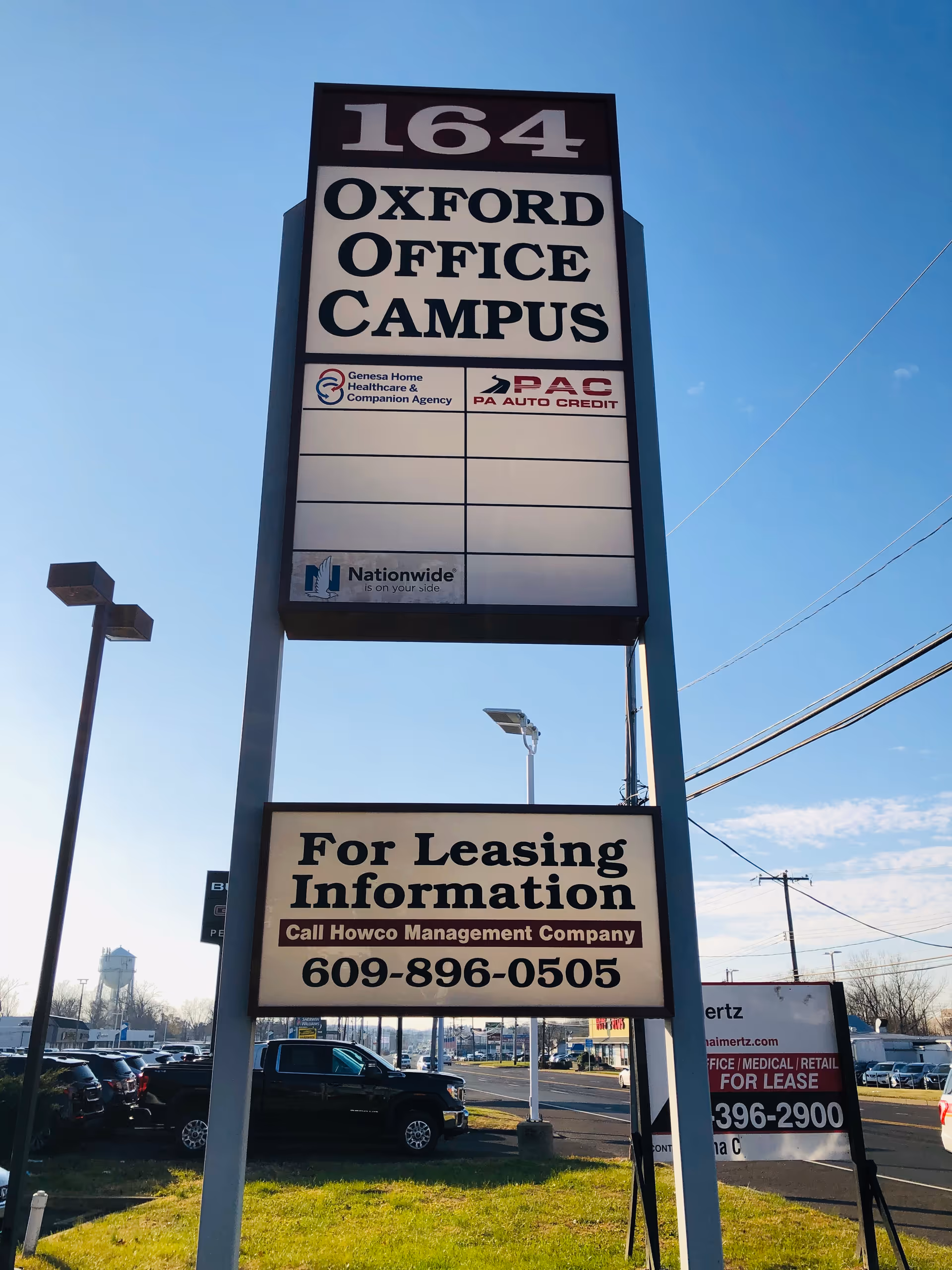 Tall outdoor sign for Genesa Home Healthcare; Oxford Office Campus leasing information.