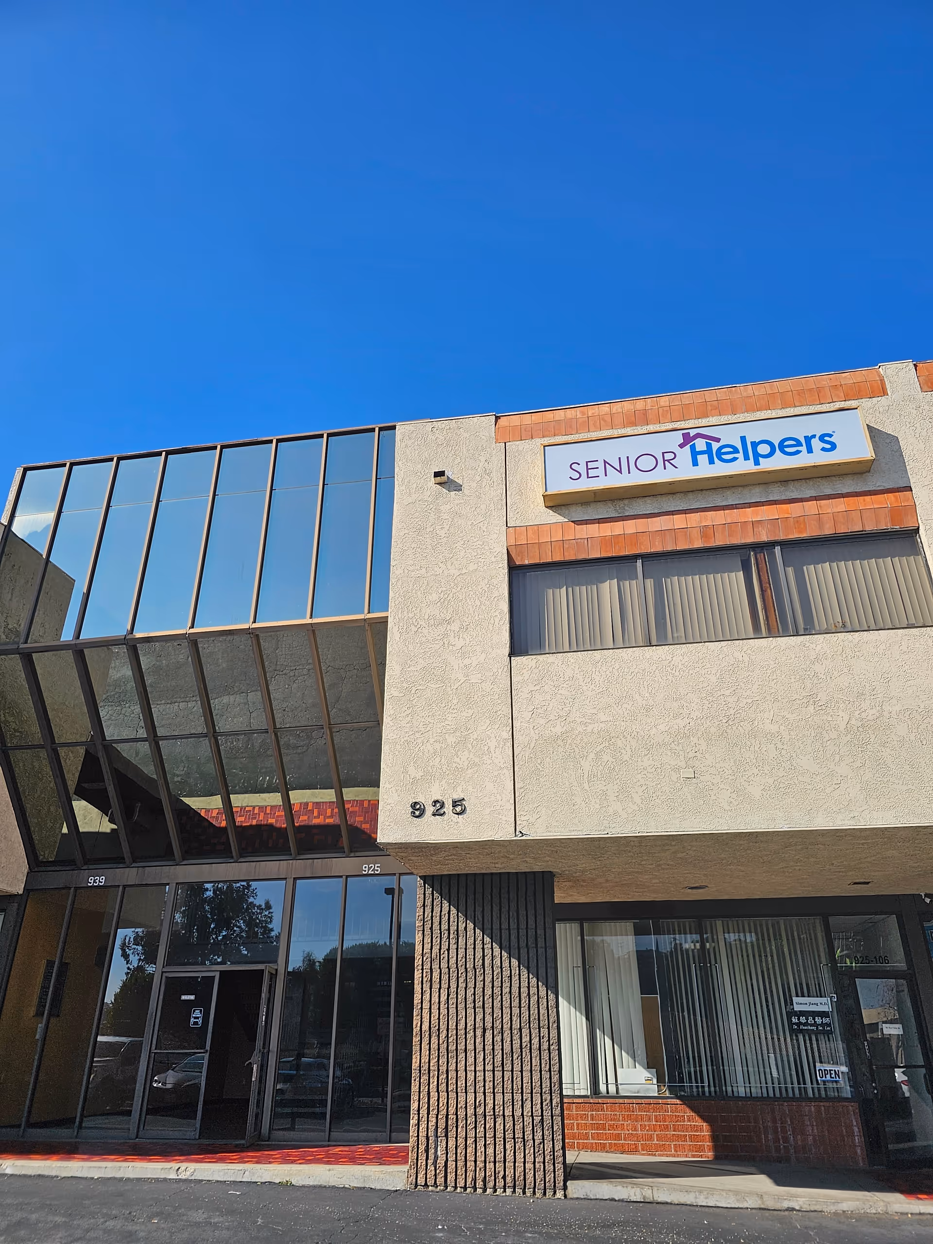Exterior view of a Senior Helpers facility with a sign on the front facade.