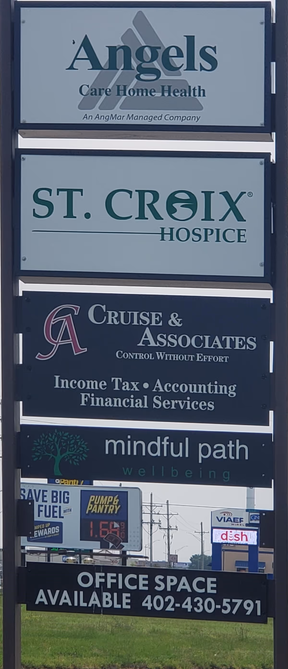Outdoor signpost featuring St. Croix Hospice among multiple senior care signs.