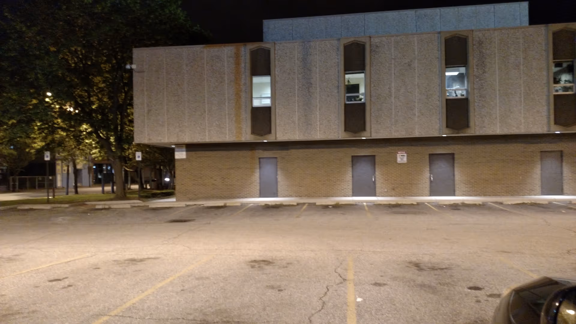 Night exterior view of Thomas F. McCafferty Health Center with a parking lot