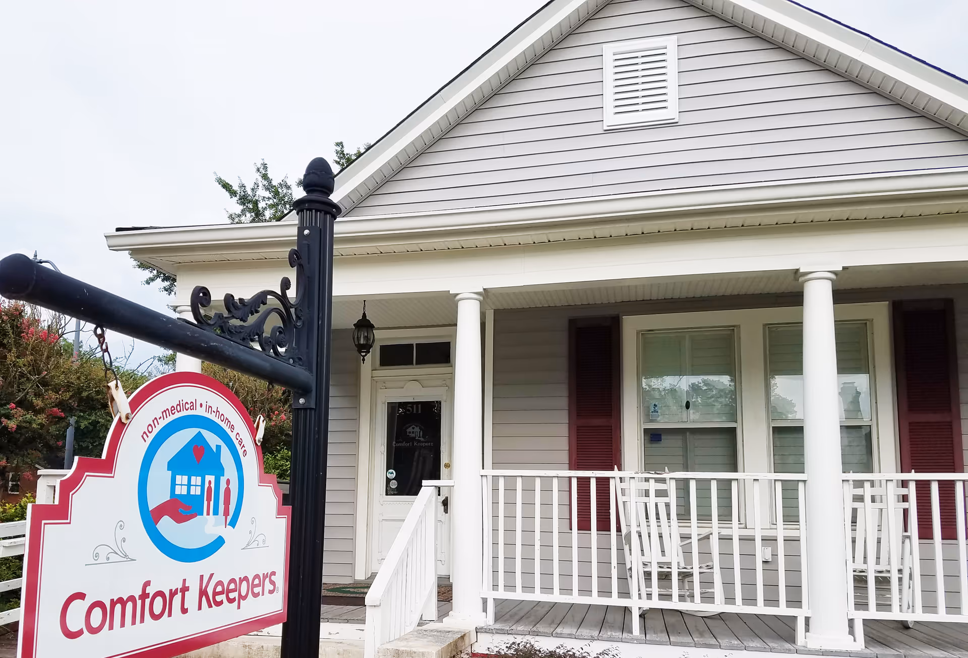 Front view of Comfort Keepers home care facility with sign and porch.