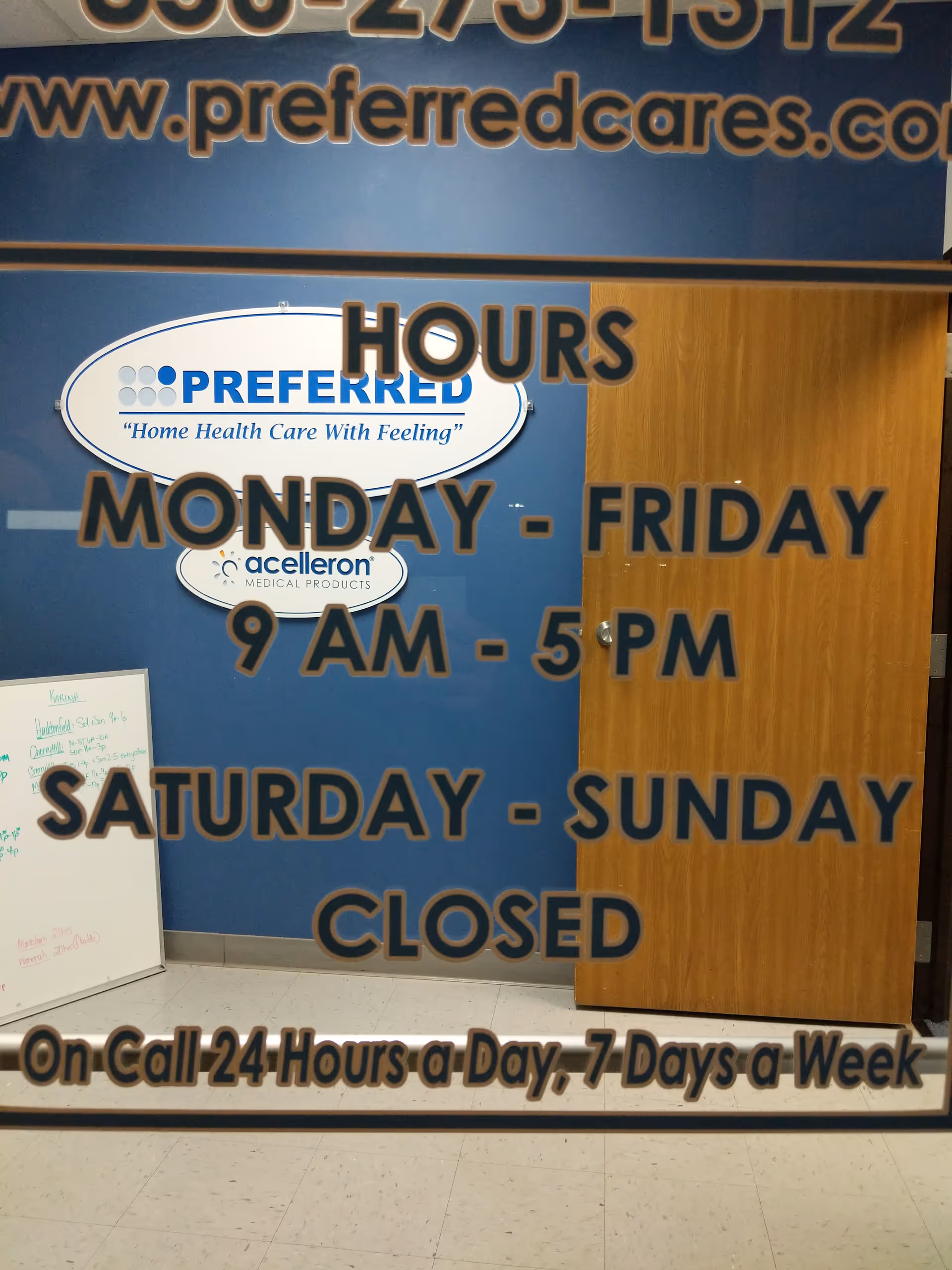 Indoor facility lobby area with blue wall, wooden door, and large 'Hours' sign.