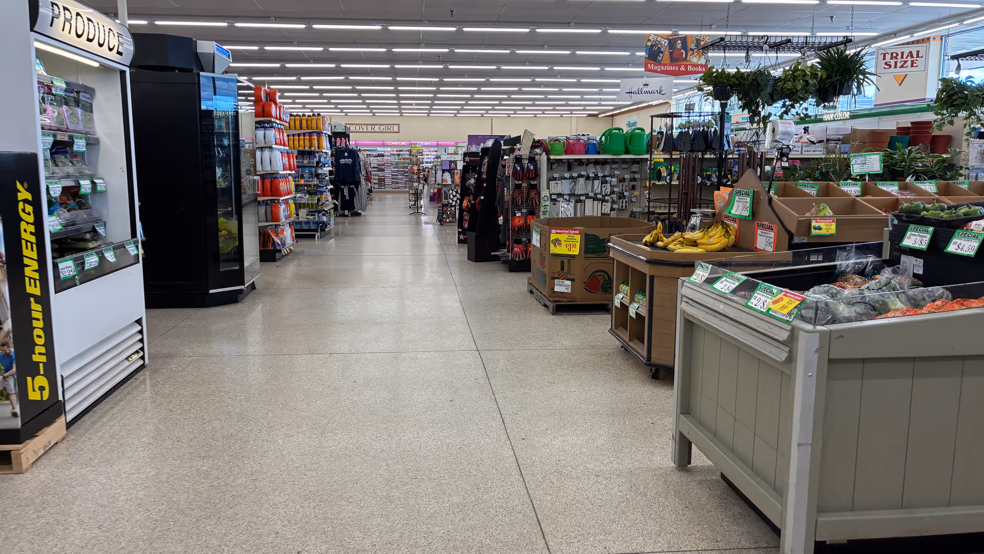 Inside a Discount Drug Mart store: wide aisles, shelves, and fruit stands.