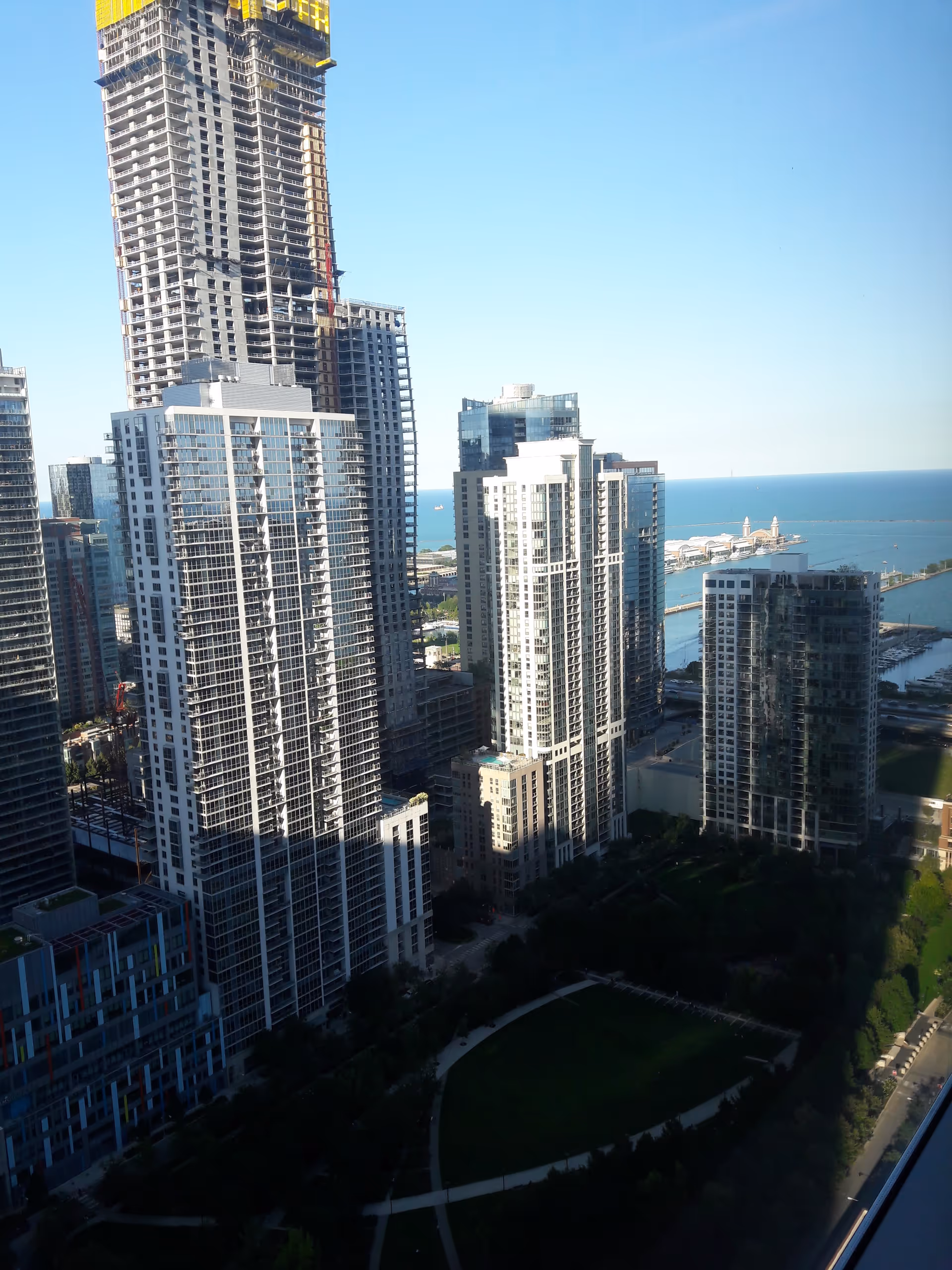 A city skyline with tall modern high-rise buildings by the waterfront.