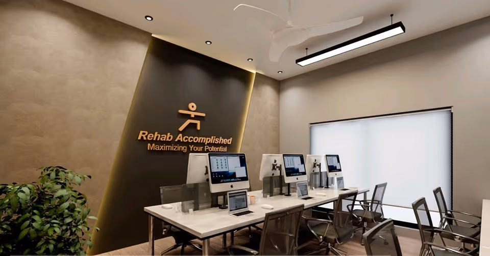Modern interior with row of computer stations and Rehab Accomplished sign on wall.