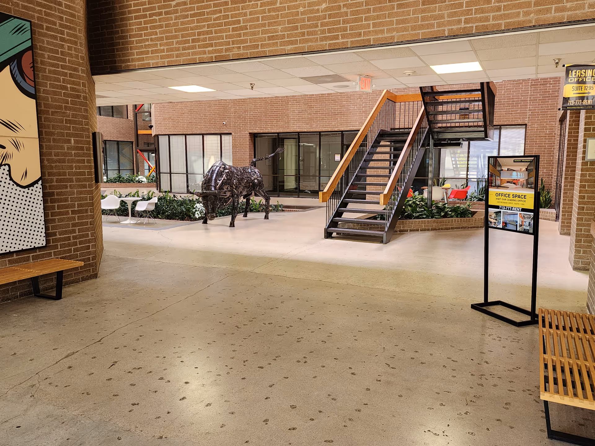 Indoor lobby of SimplyVital Home Care facility featuring a metallic cow sculpture and seating.