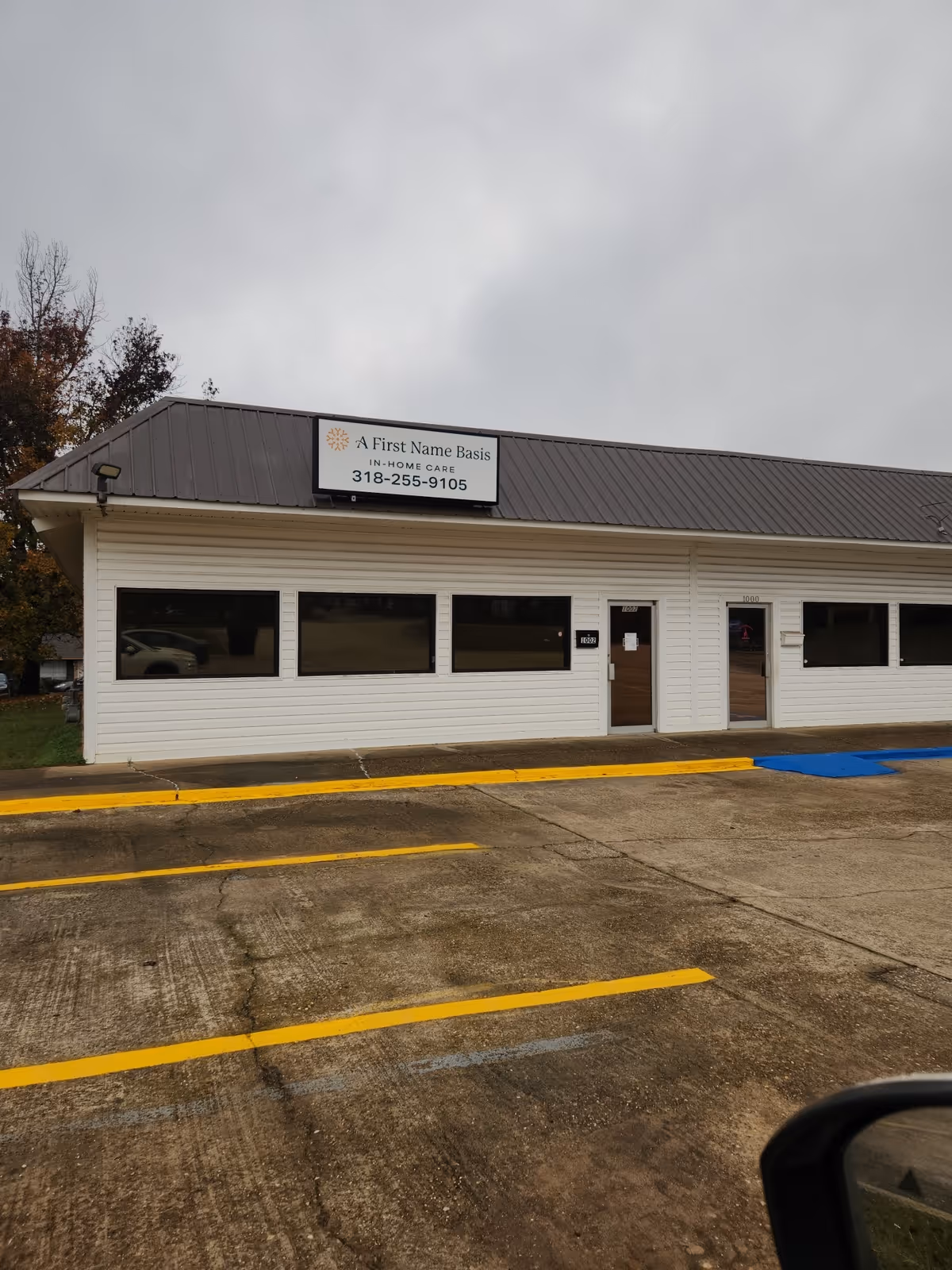 Exterior view of A First Name Basis Ruston senior care building with a parking lot.