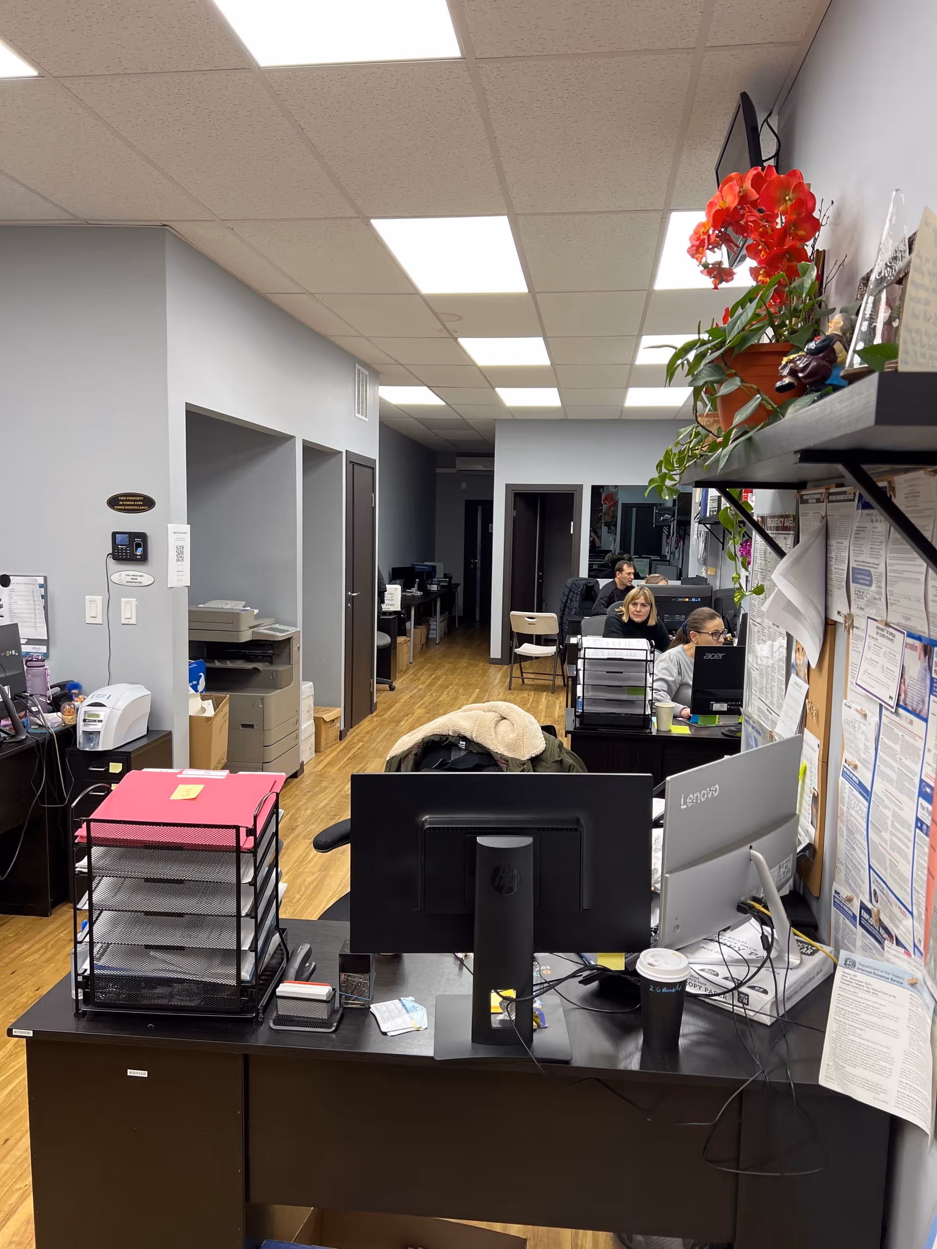 Interior office area at Magic Home Care with front desk, computers, and staff.