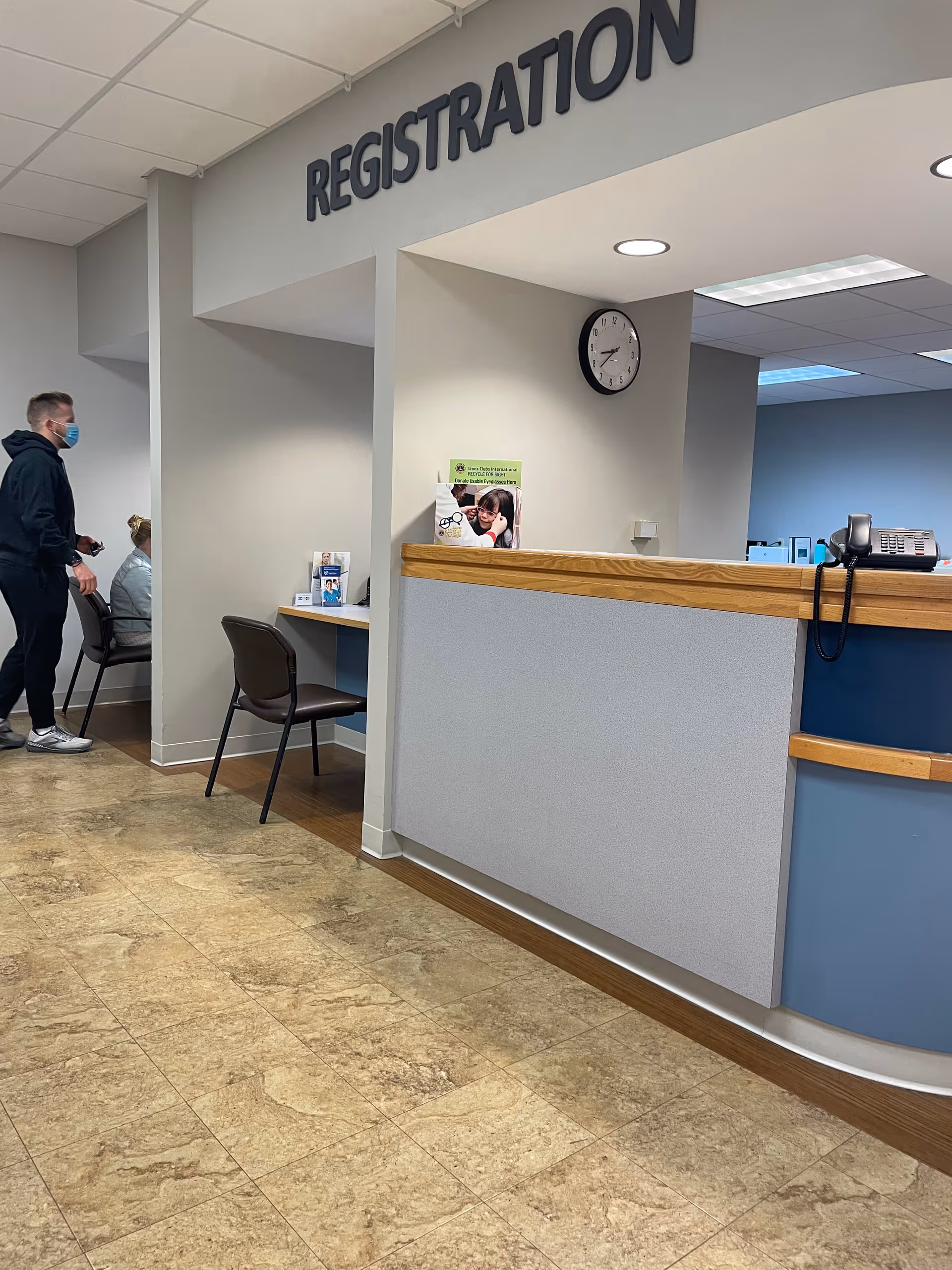 Registration counter with clock and seating inside a medical facility