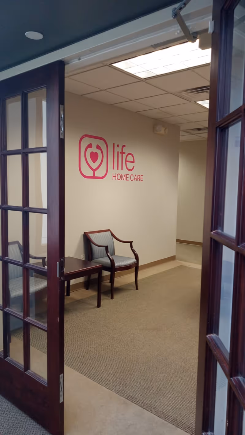 Interior hallway with Life Home Care logo and two waiting chairs