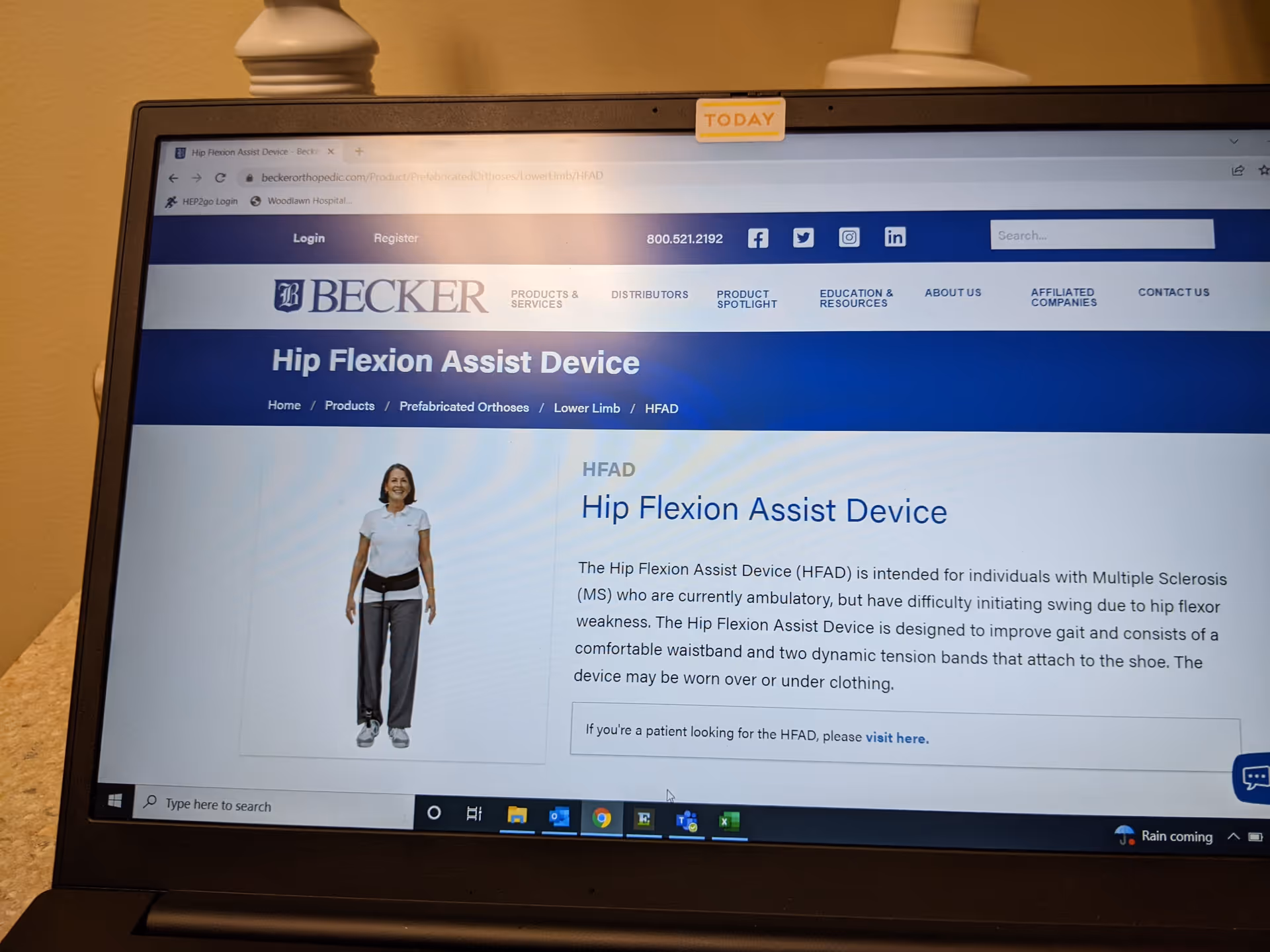 Laptop screen displaying a Becker Hip Flexion Assist Device webpage with a model image.