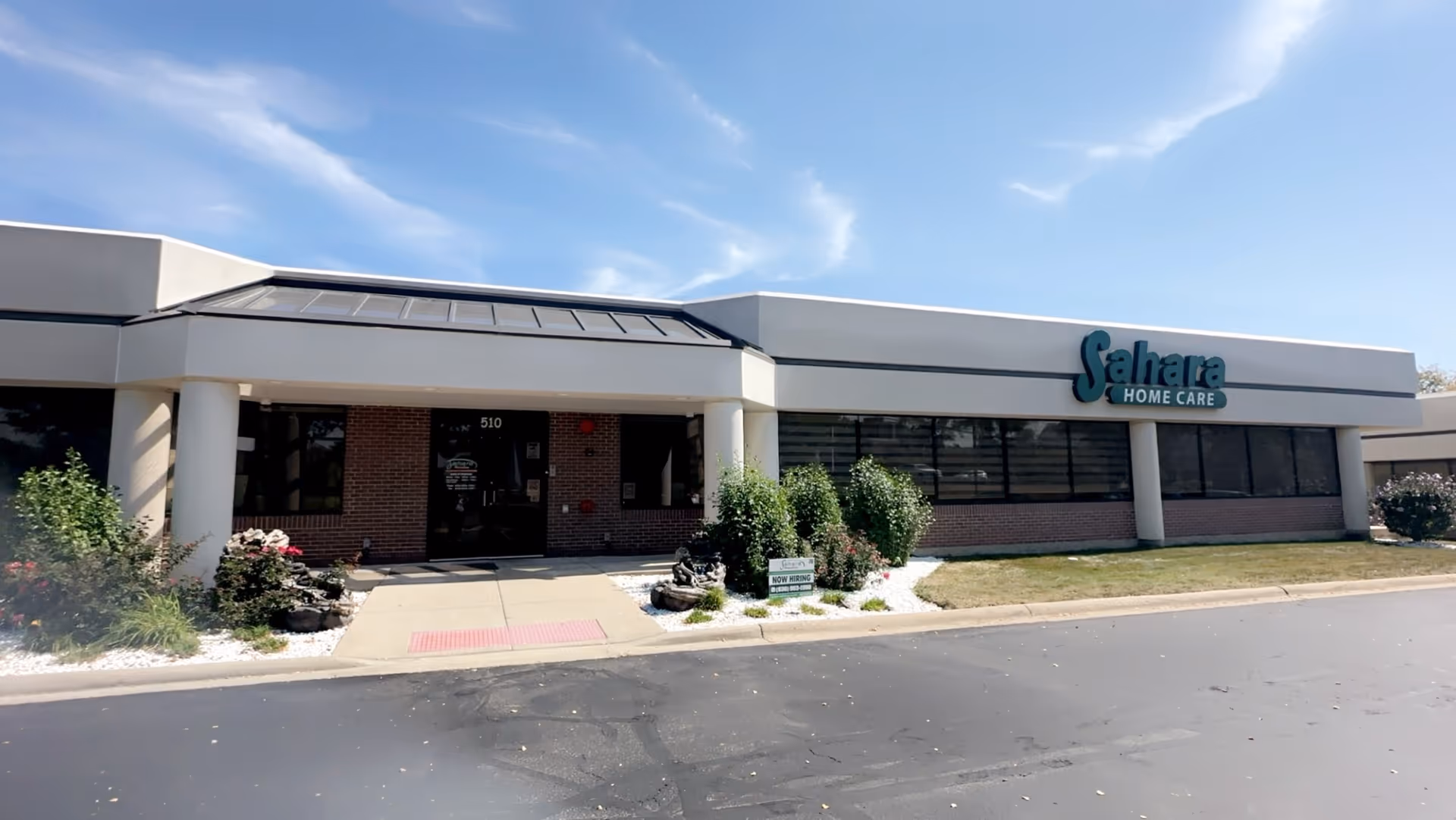Front exterior of Sahara Home Care facility with entrance and sign