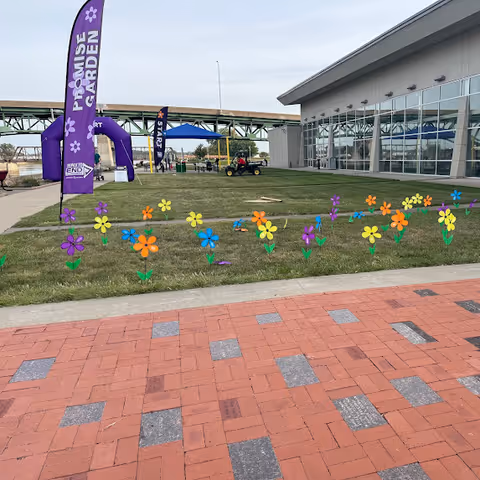 Exterior view of Home Halo of Iowa with colorful lawn flowers and banners.