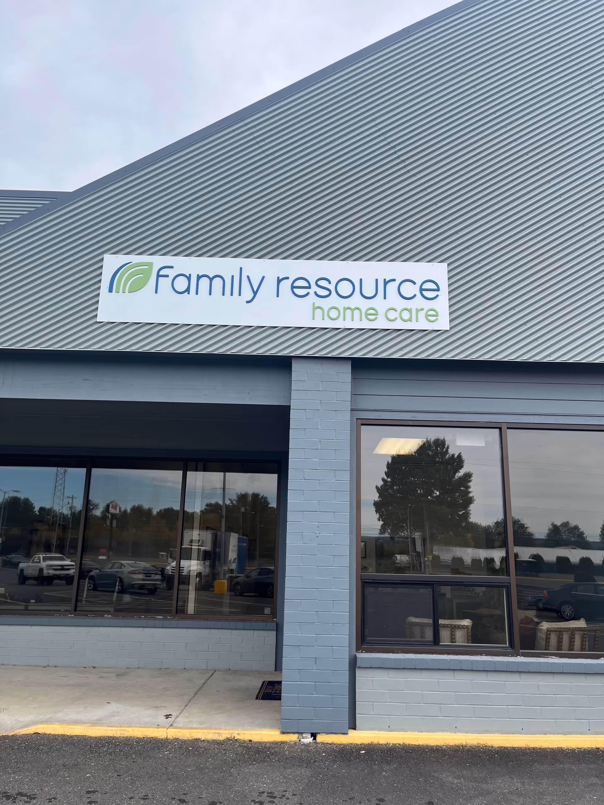 Exterior storefront with a Family Resource Home Care sign on the building front.