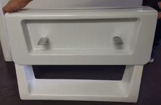 White hollow rectangular display stand with two metal handles on top.