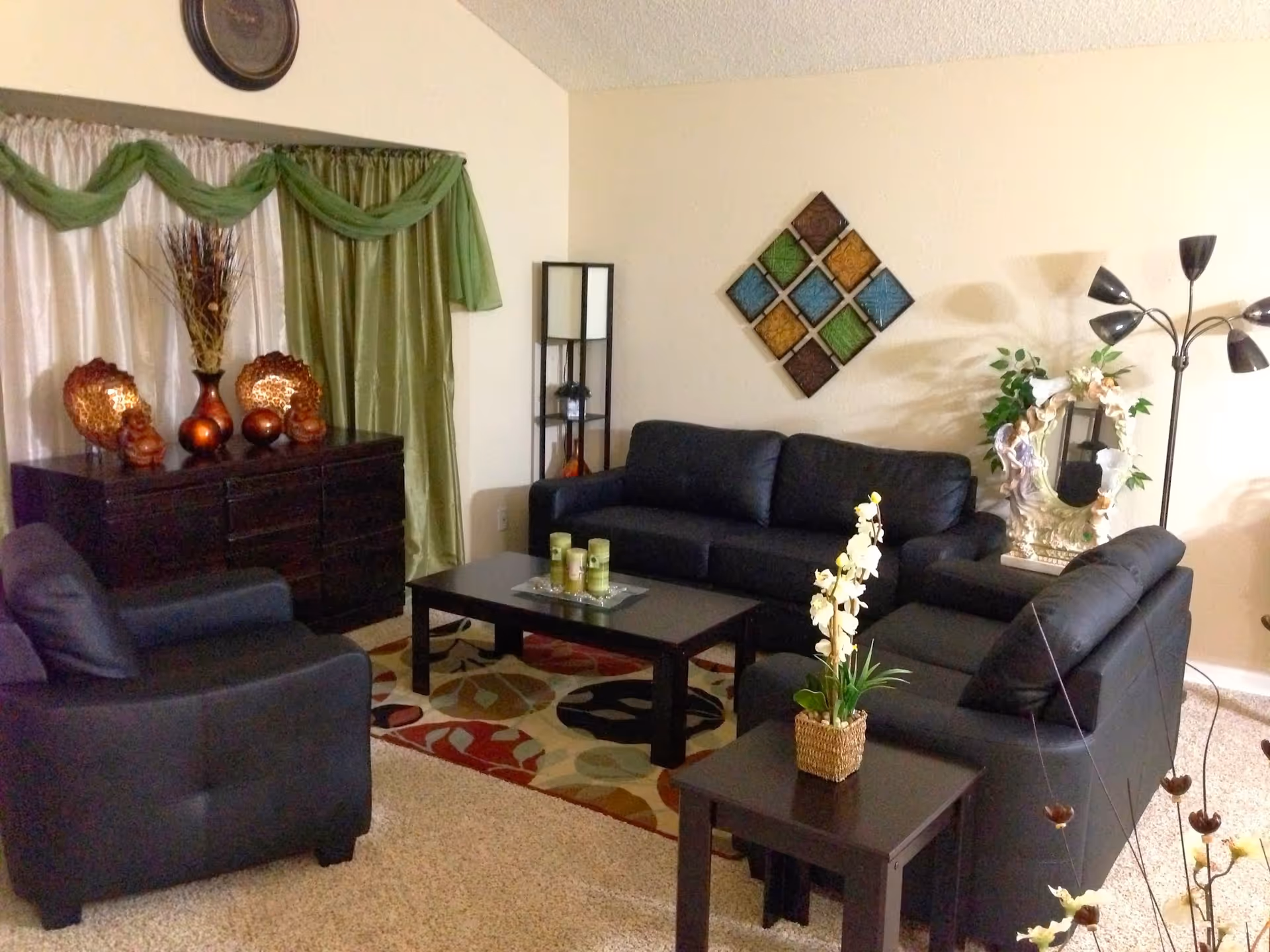 Cozy living room with dark sofas, coffee table, and decorative ornaments.