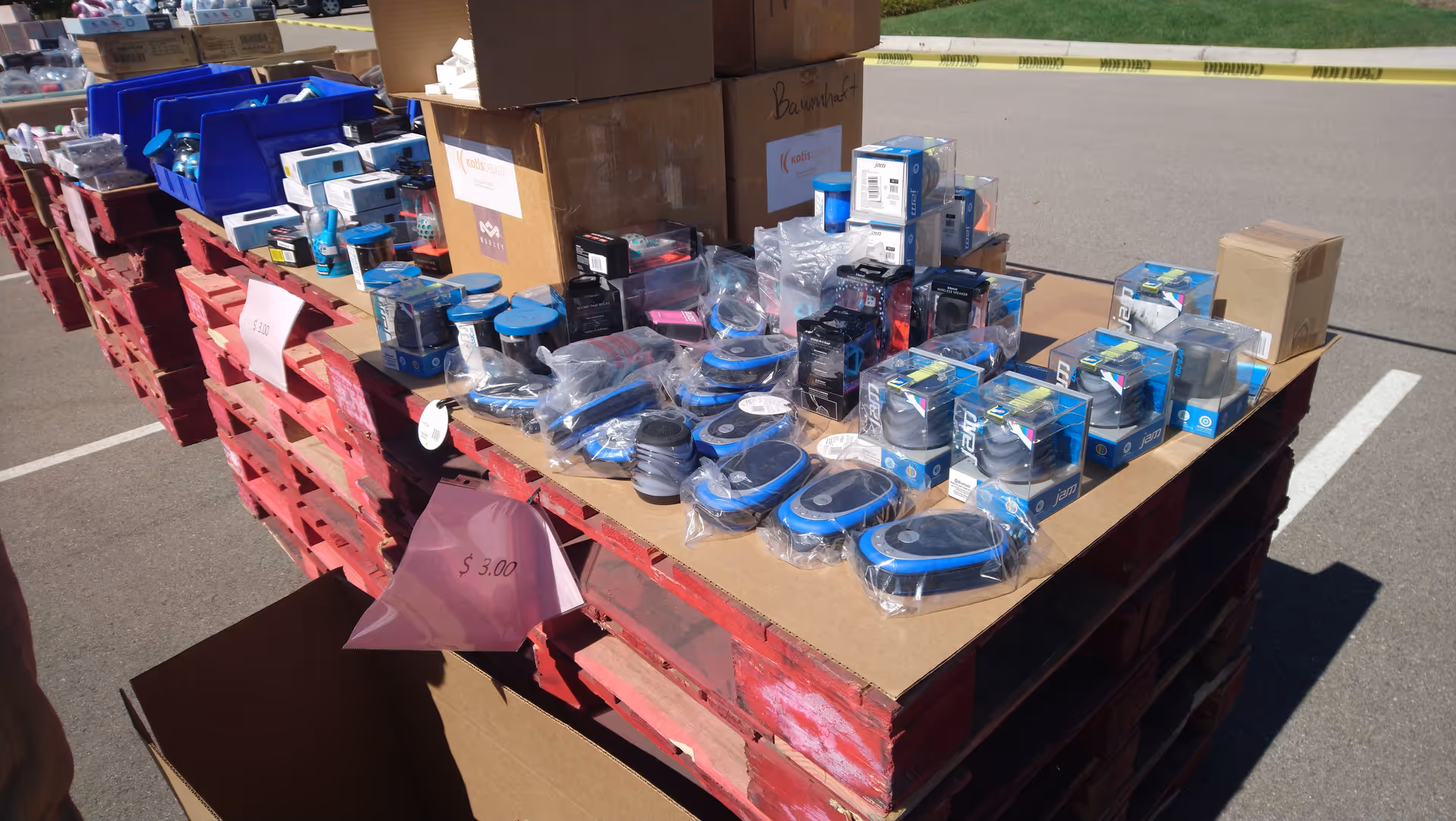 Outdoor display of HoMedics products arranged on pallets in a parking lot.