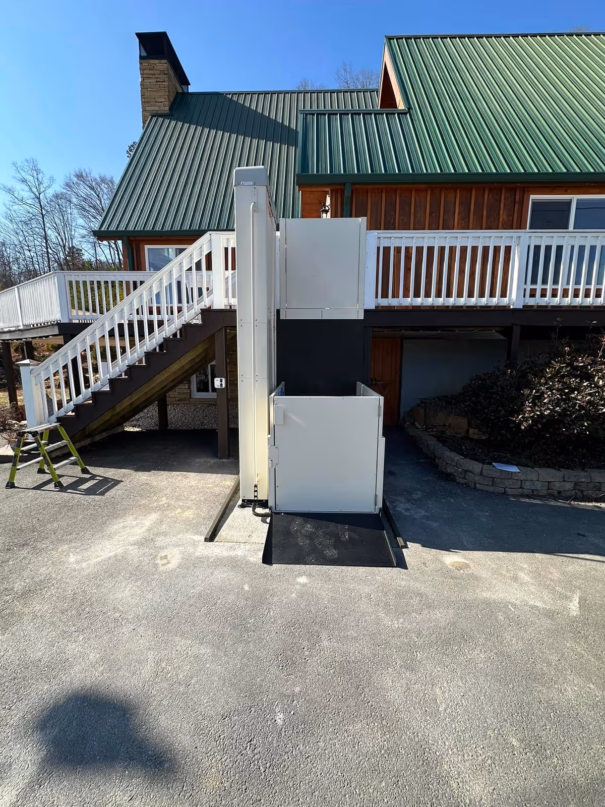 Exterior view of a senior facility with an outdoor wheelchair lift beside stairs
