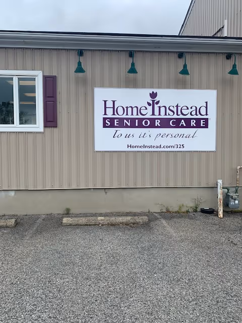 Exterior view of a Home Instead Senior Care facility with a large sign.