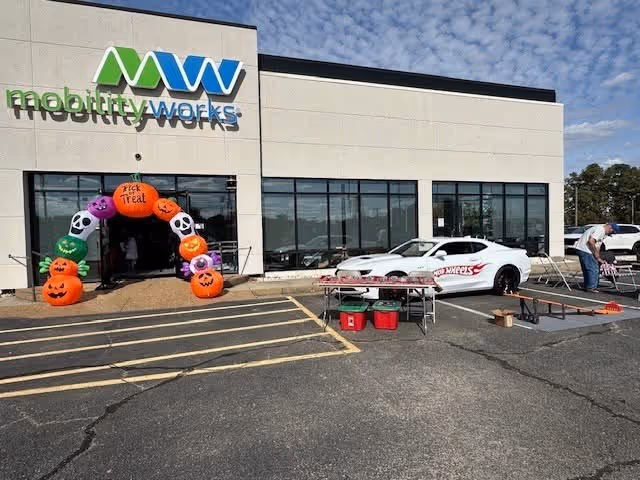 Exterior view of MobilityWorks facility with a Halloween pumpkin arch at the entrance.