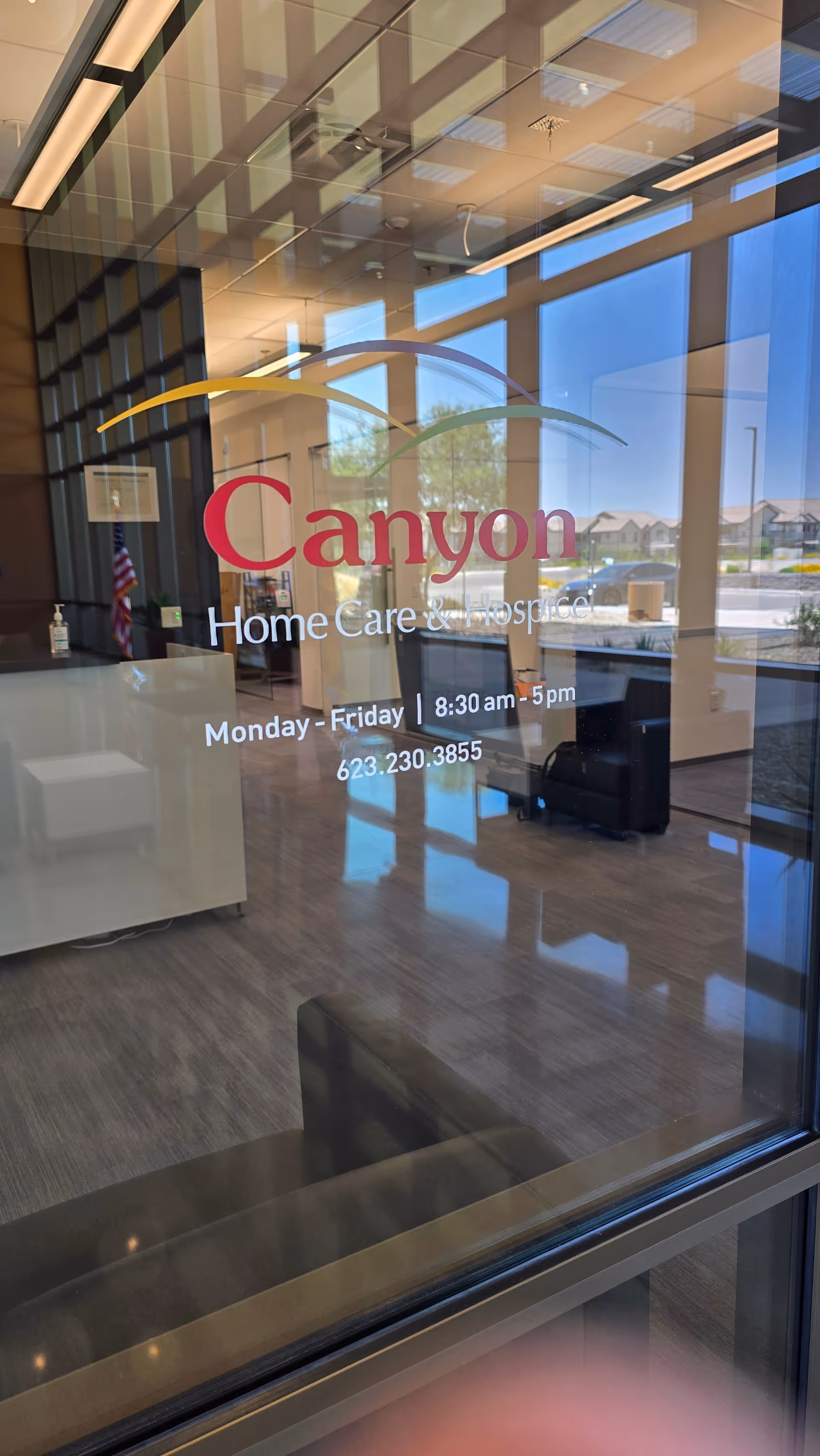 Glass-walled lobby of Canyon Home Care & Hospice with seating and reception.