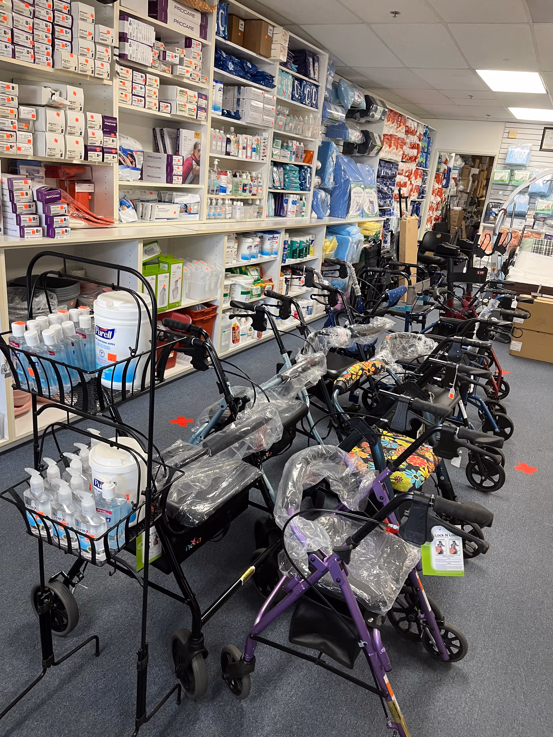 Rows of walkers and mobility aids lined up in a medical supply room.