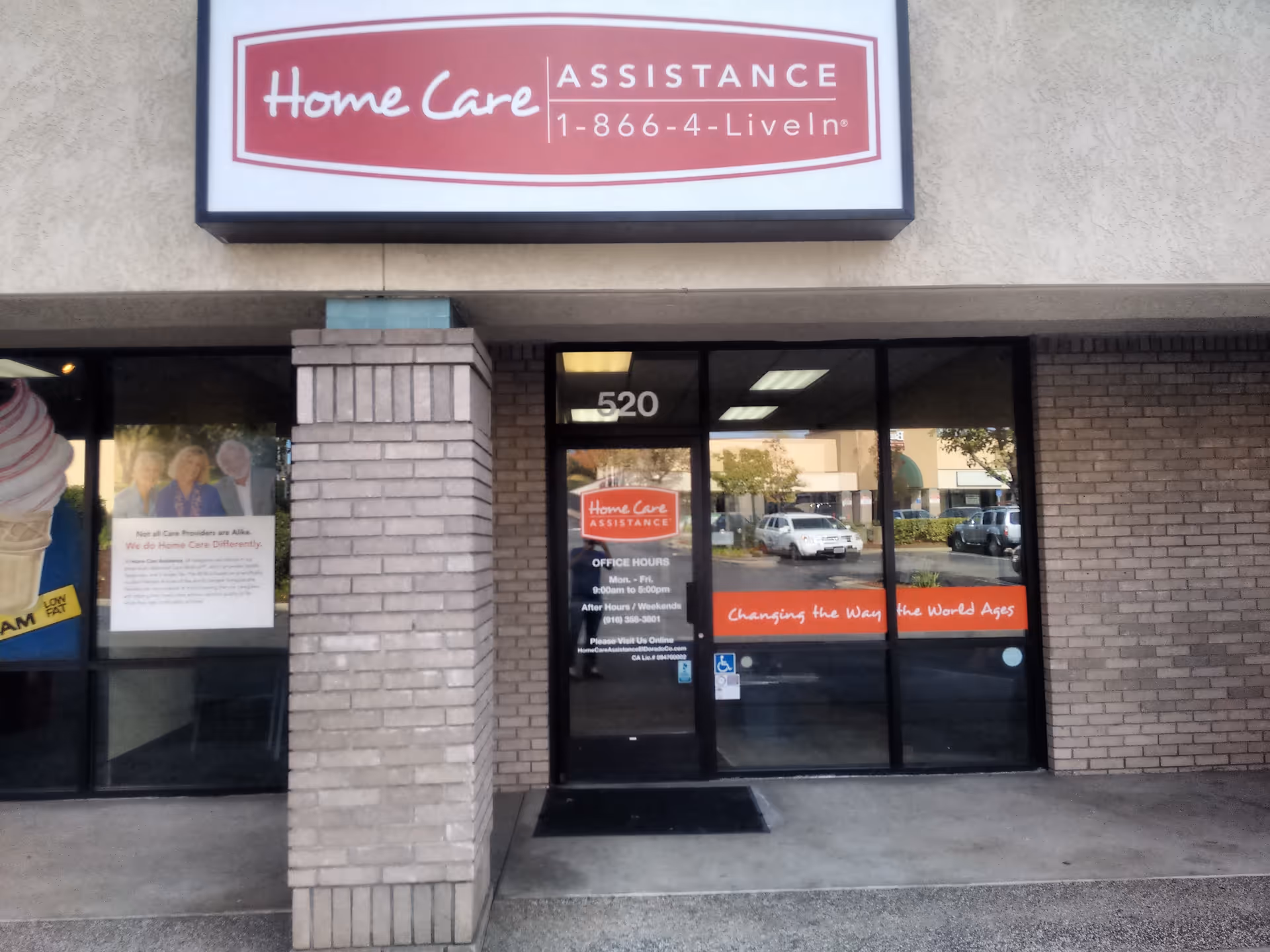Front entrance of a senior home care facility with glass doors and a large sign.