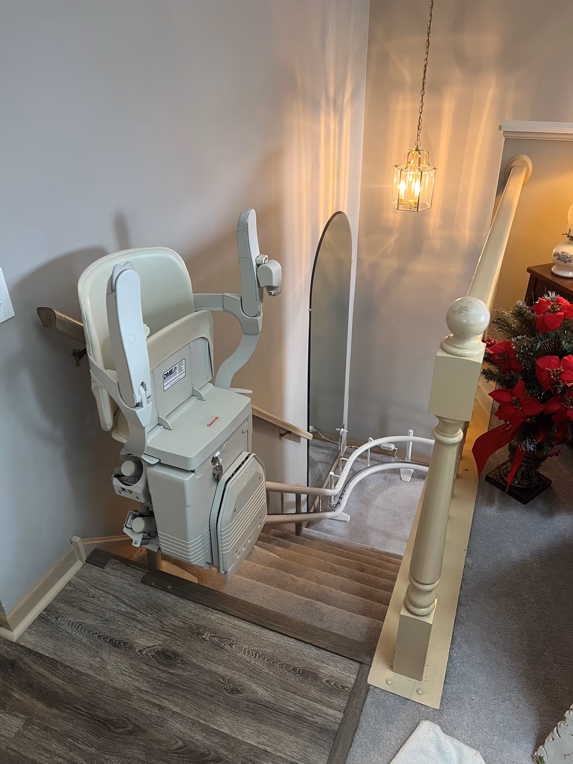 Indoor staircase with a mounted stair lift in a home-like facility.