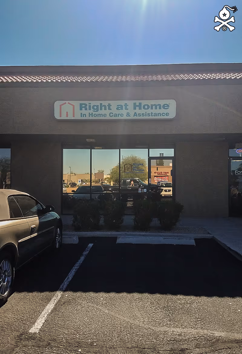 Exterior view of Right at Home storefront with sign and parking lot.