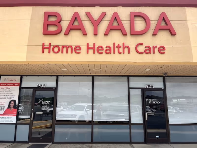 Storefront of BAYADA Home Health Care with a large red sign.