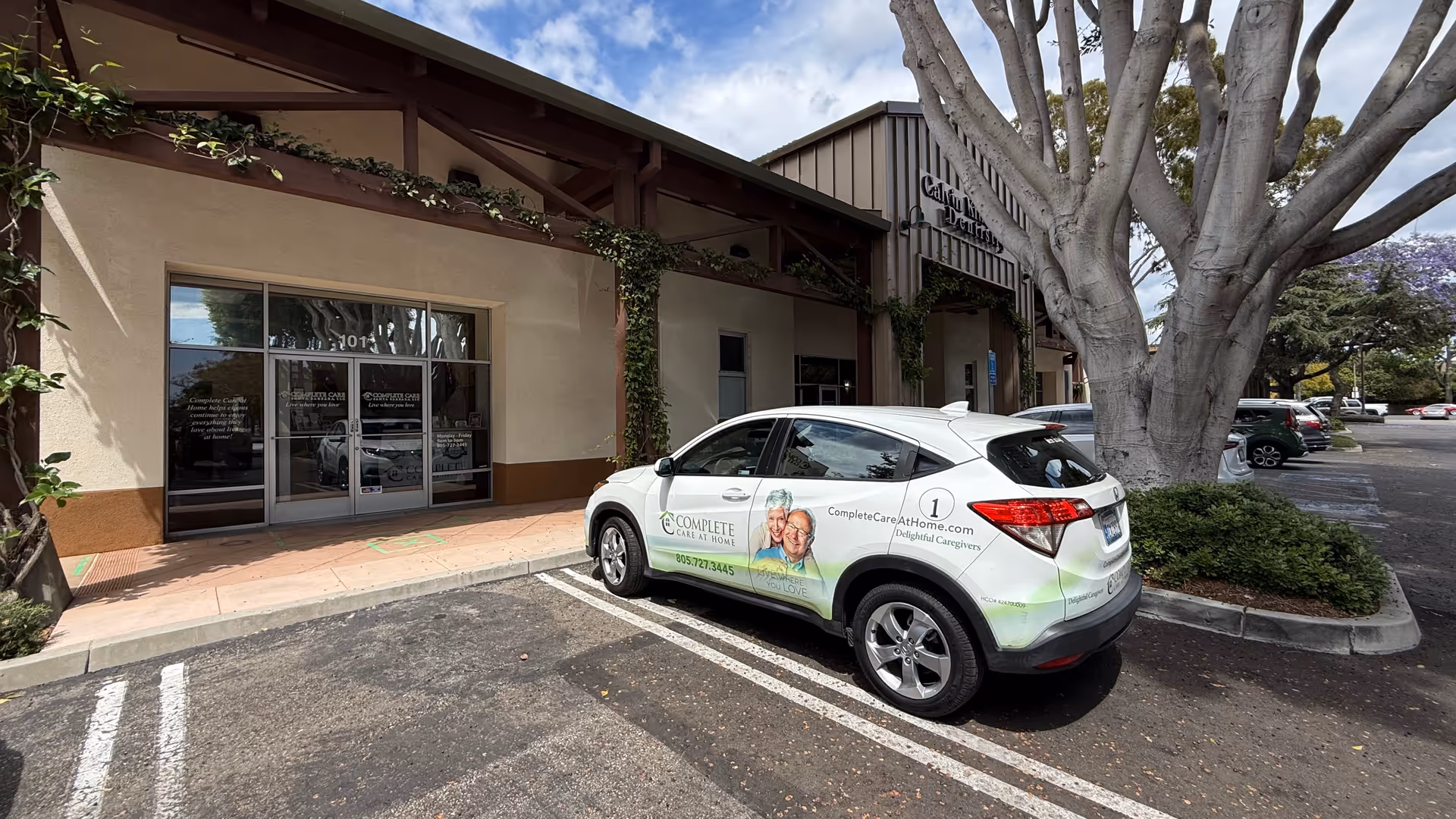 Exterior view of Complete Care at Home building with a branded car parked outside.
