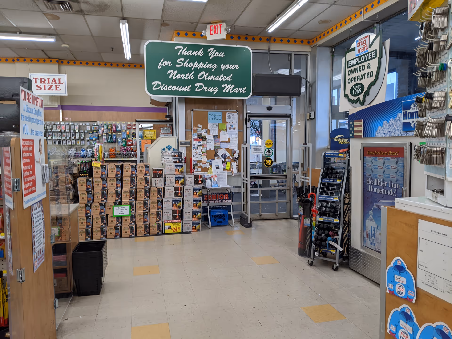 Interior of a Discount Drug Mart with aisles, shelves stacked with boxes and products.