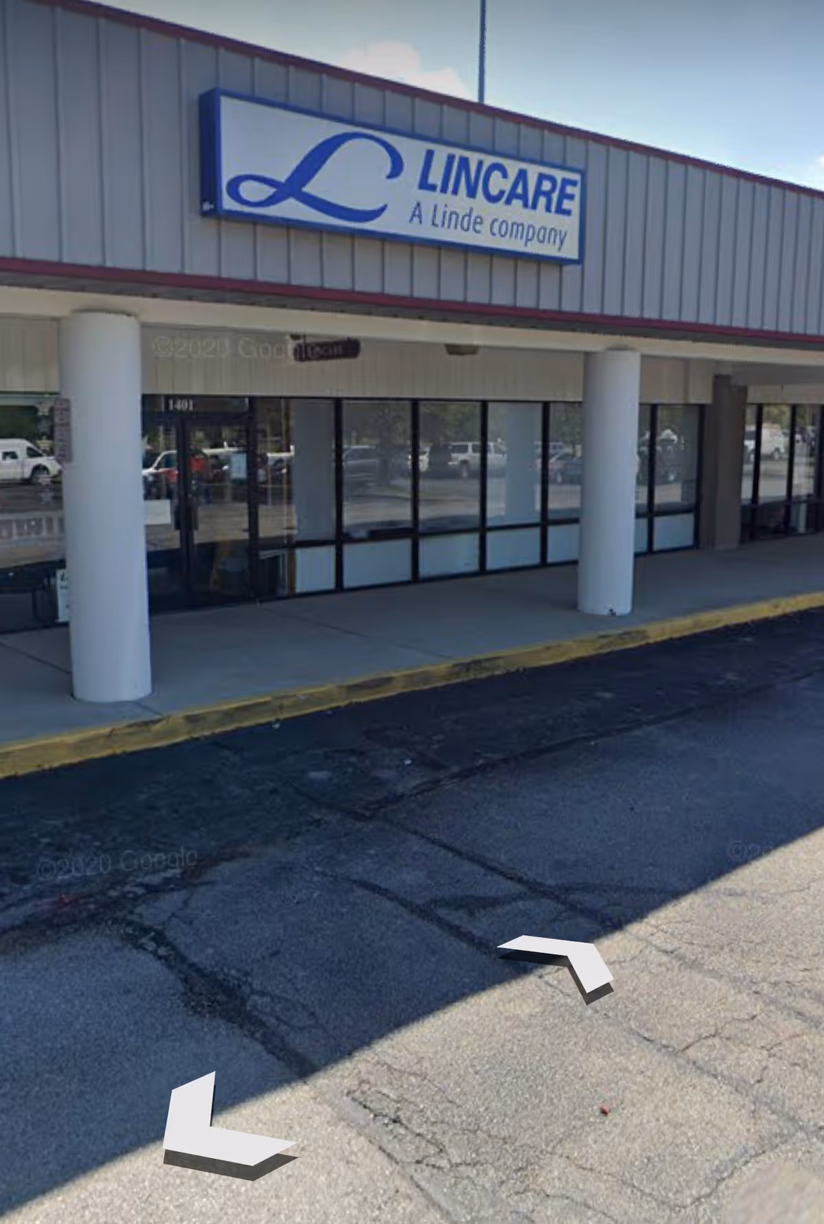 Exterior view of a LINCARE storefront with glass windows and blue sign.
