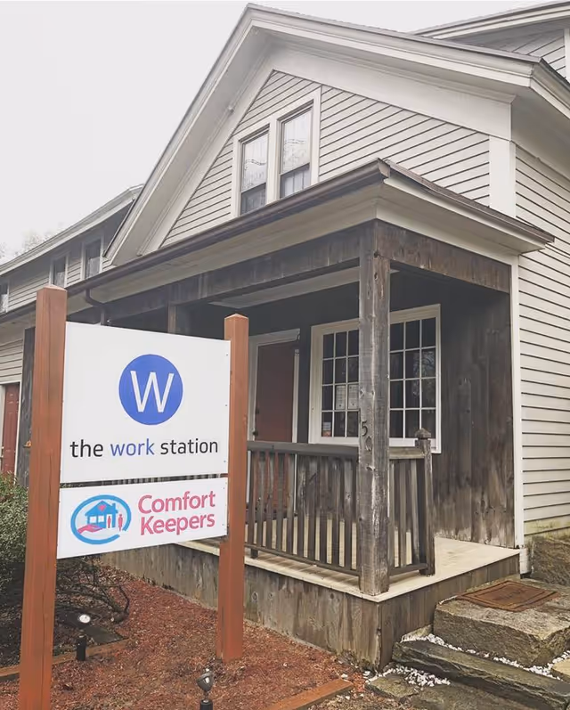 Exterior of Comfort Keepers Home Care facility with entrance porch and signage.